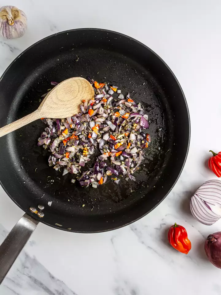 Onion, garlic, and chillies sizzled in a skillet