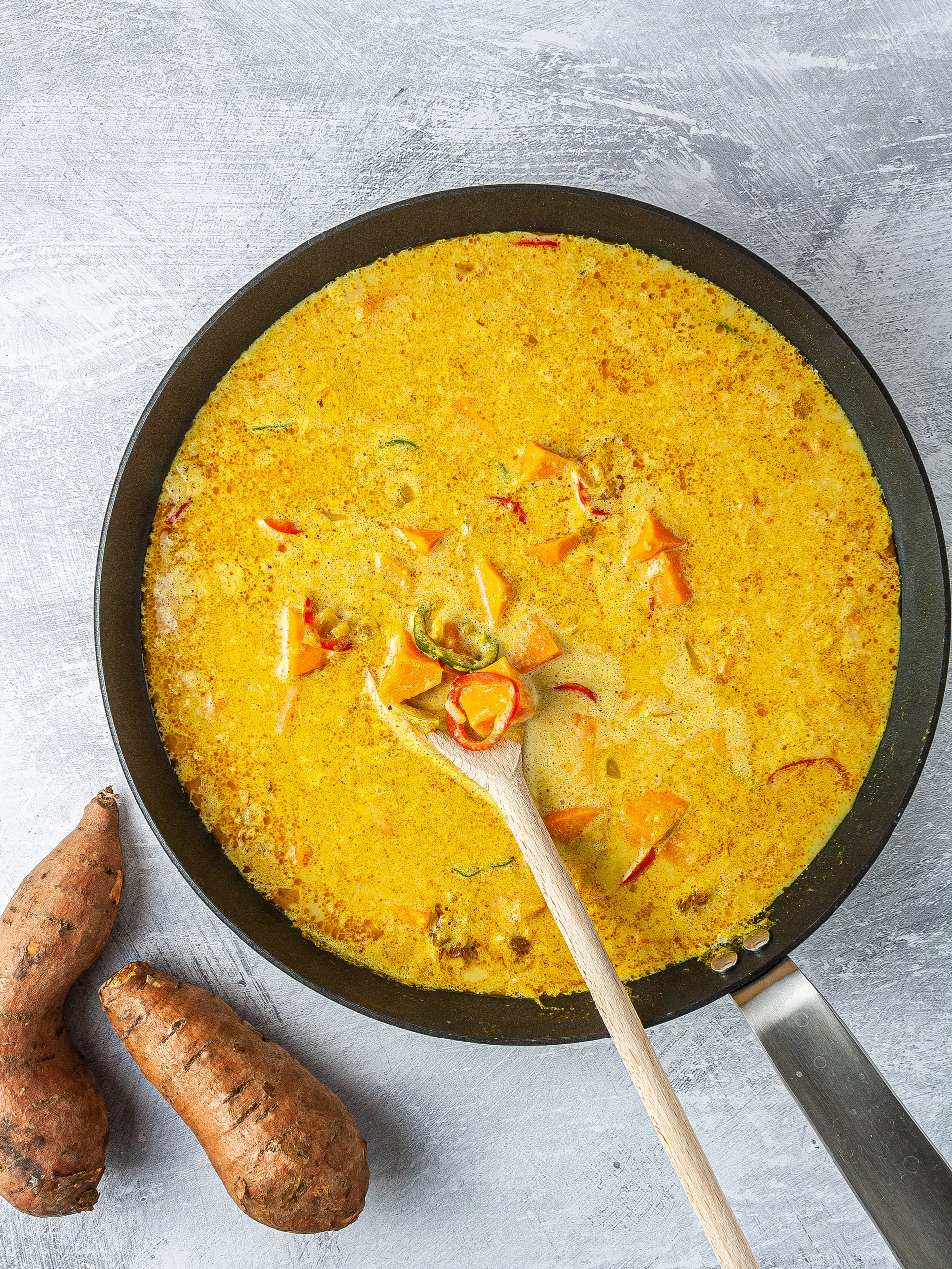 Coconut milk and sweet potatoes simmering in the curry.