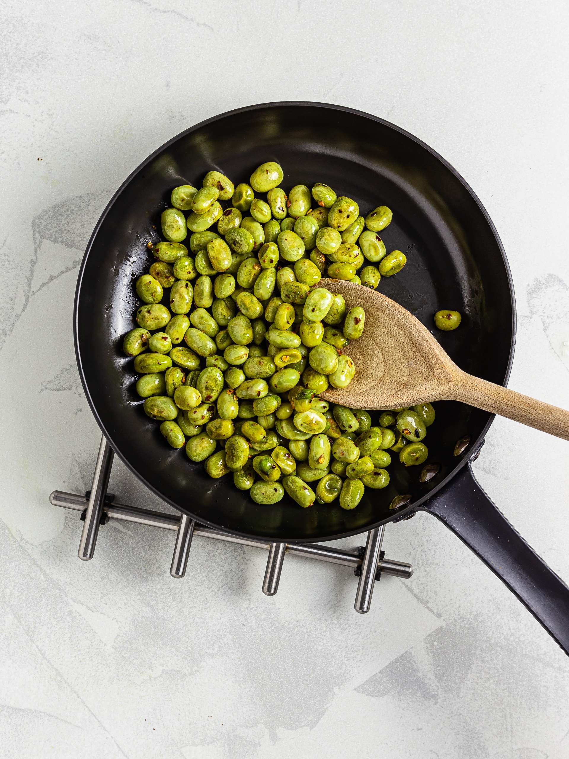 cooked broad beans in a pan