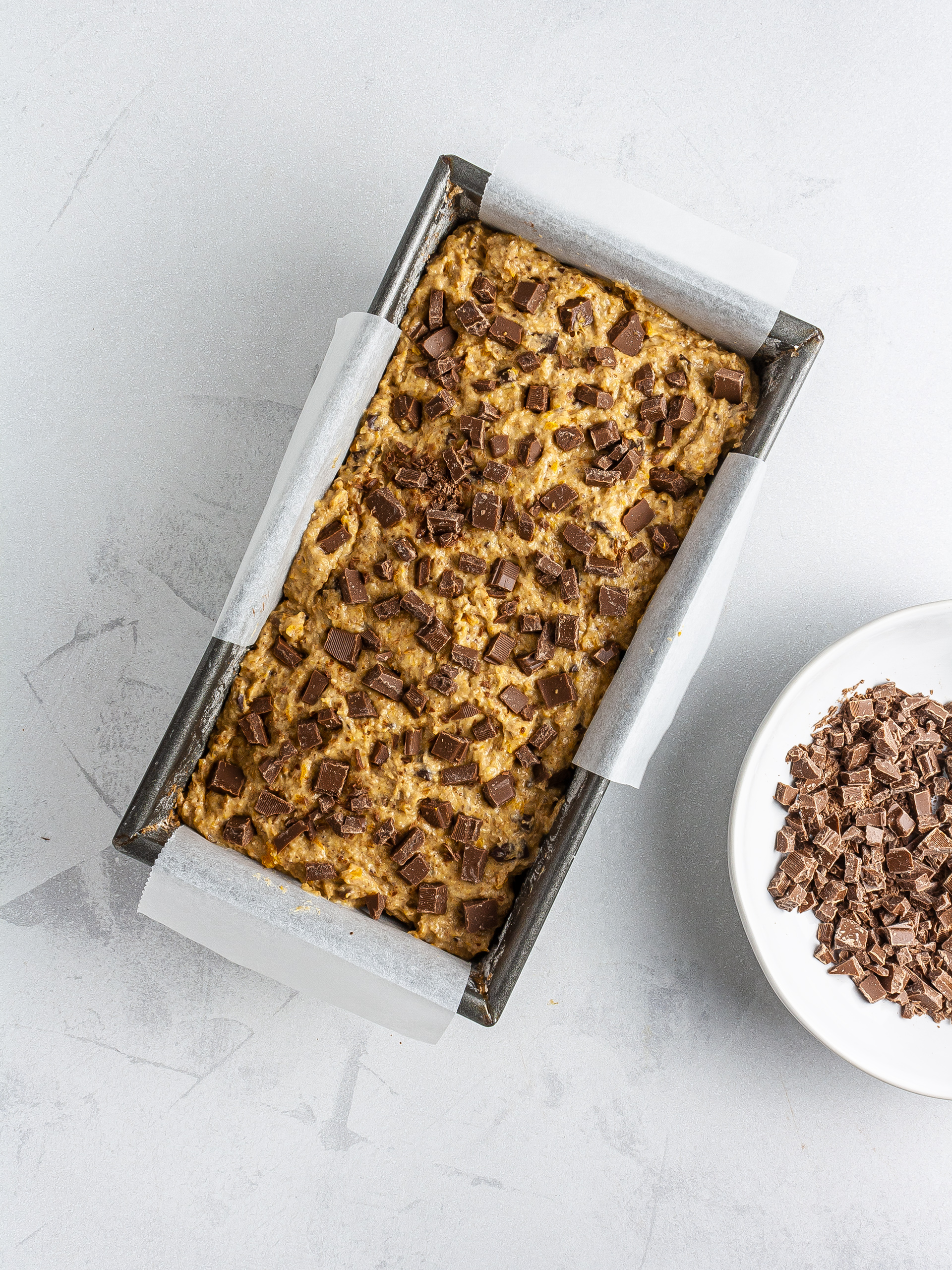 Pumpkin bread batter in loaf tin with chocolate chips