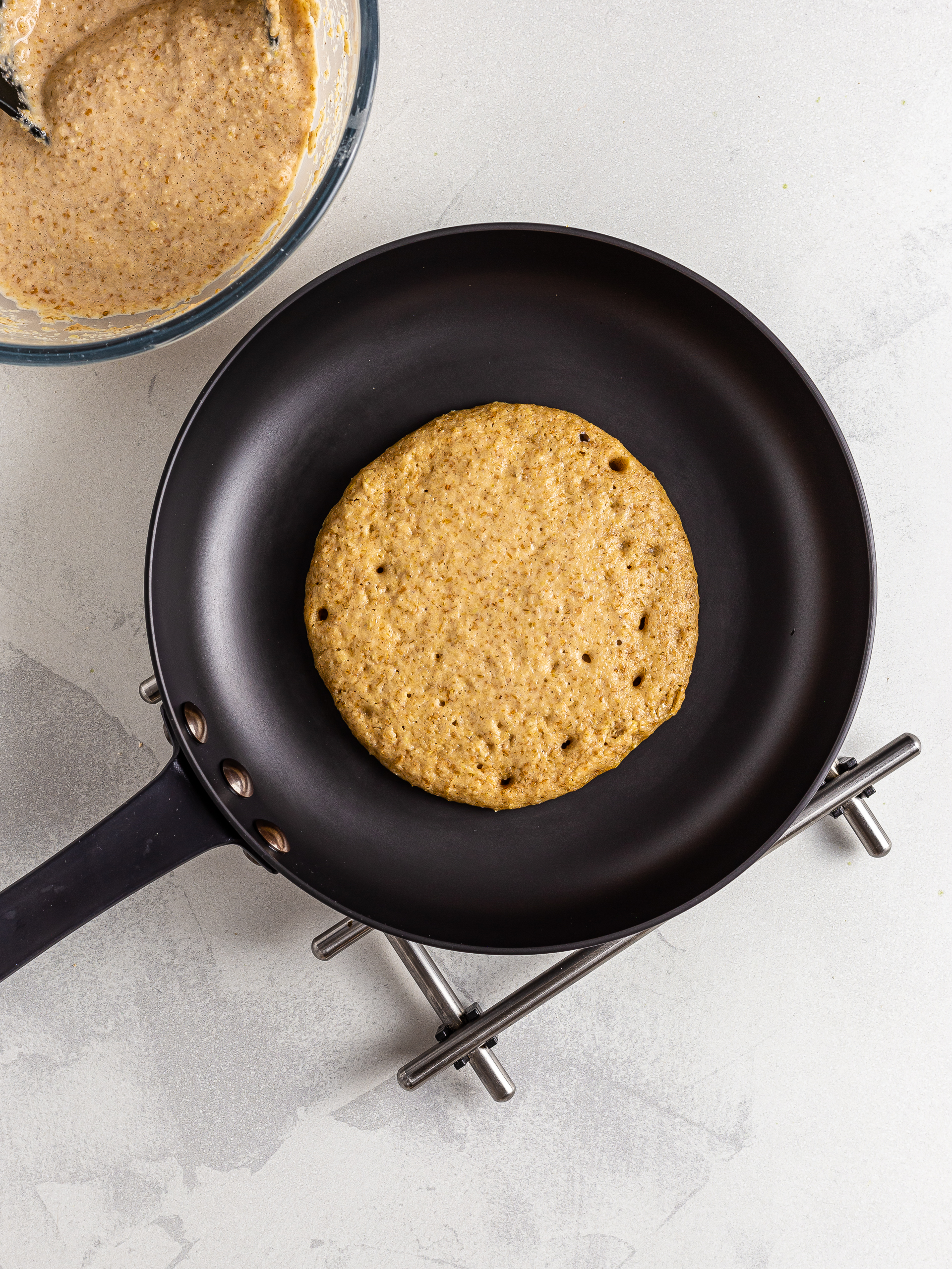 Lentil pancakes cooking in a skillet