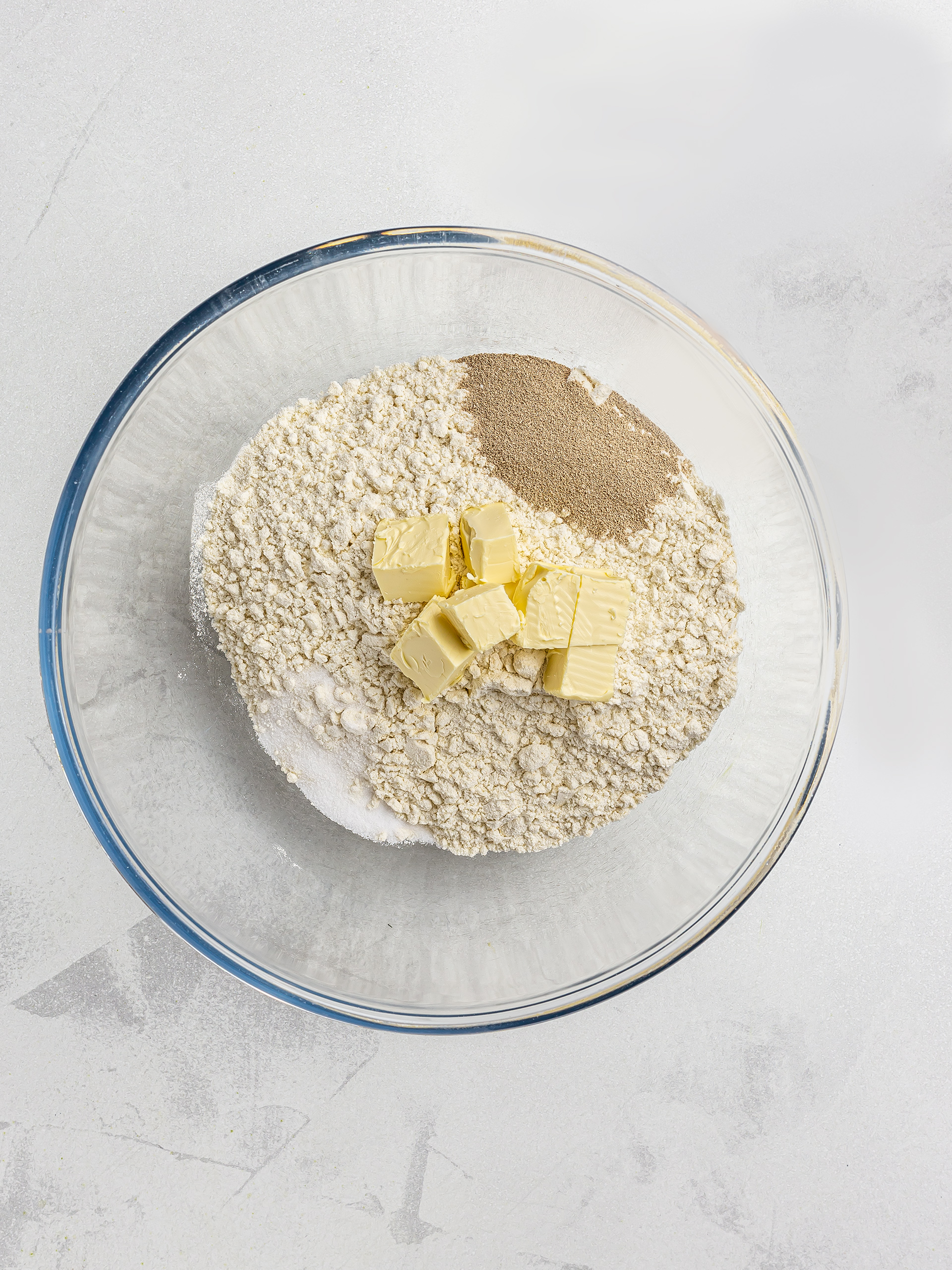 flour yeast and vegan butter in a bowl for pastry dough