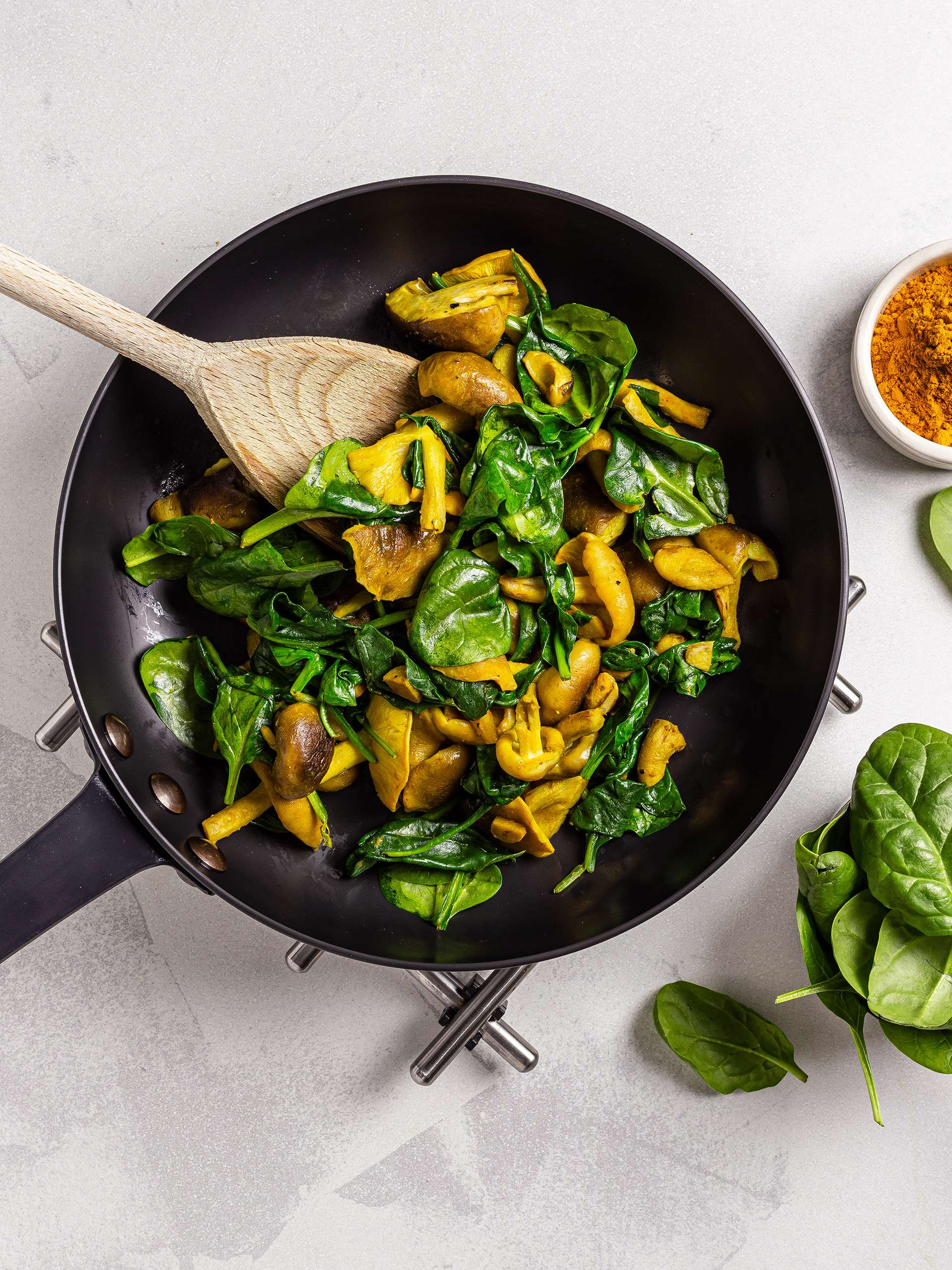 Cooked spinach and mushrooms with turmeric