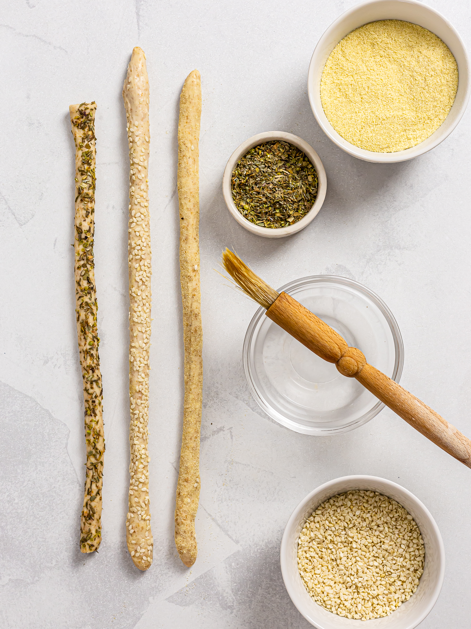 sourdough breadsticks coated with herbs, sesame seeds, and semolina