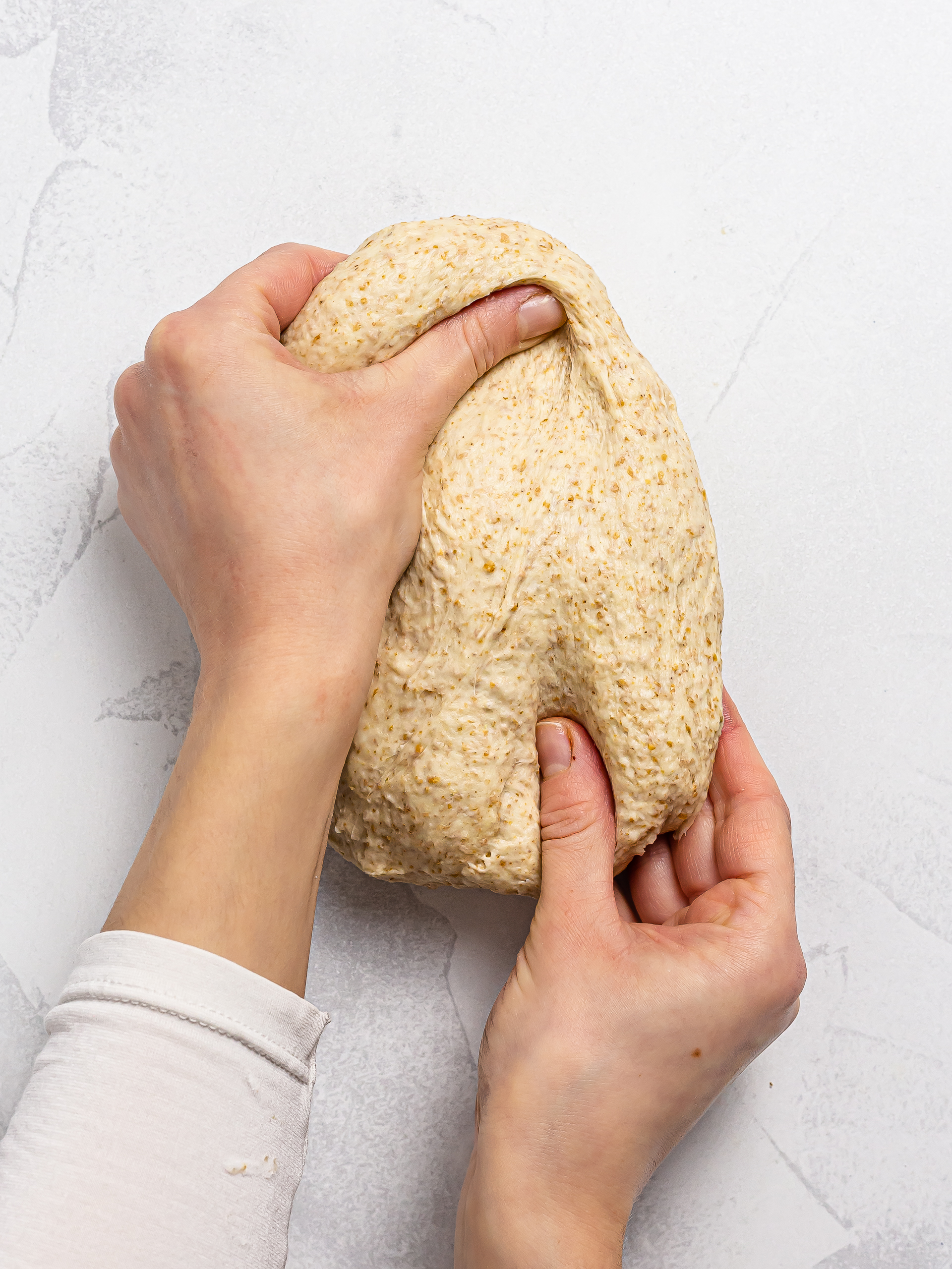 woman kneading sourdough breadsticks dough