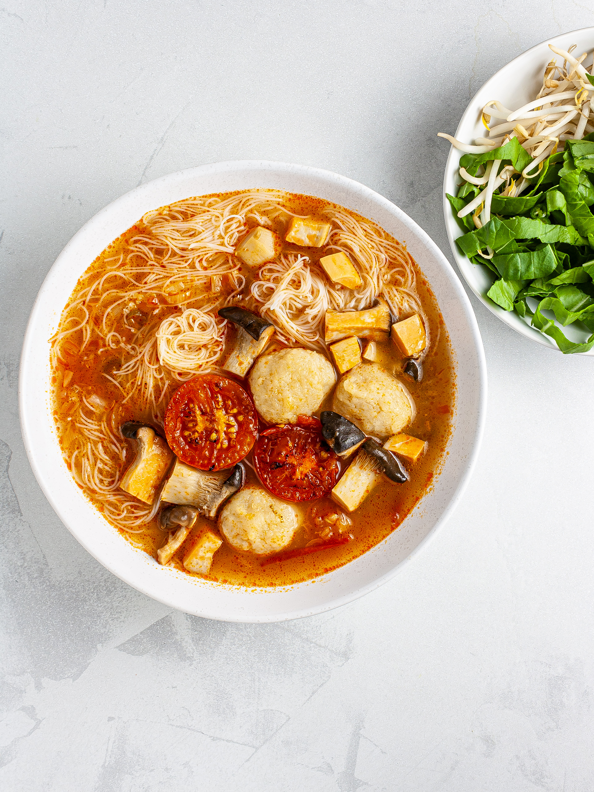 Vietnamese bun rieu with side greens