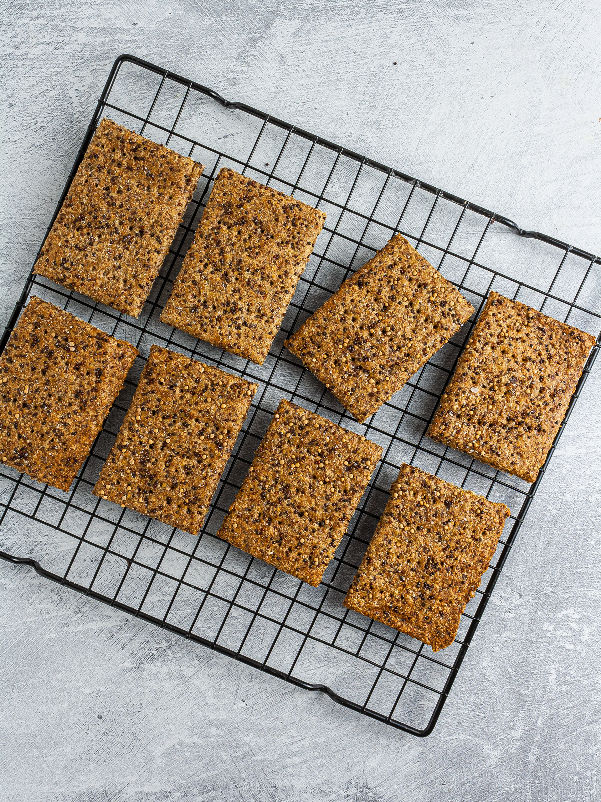 Baked mustard crackers on a wire rack