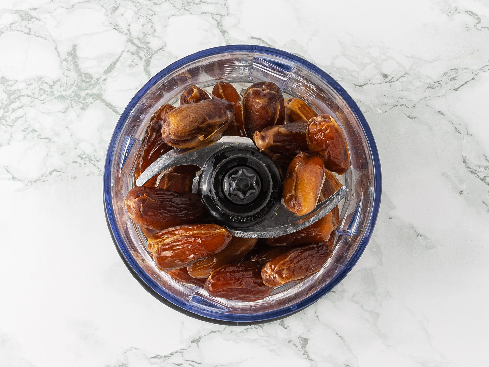 Pitted dates and water in a blender ready to be turned into a smooth paste