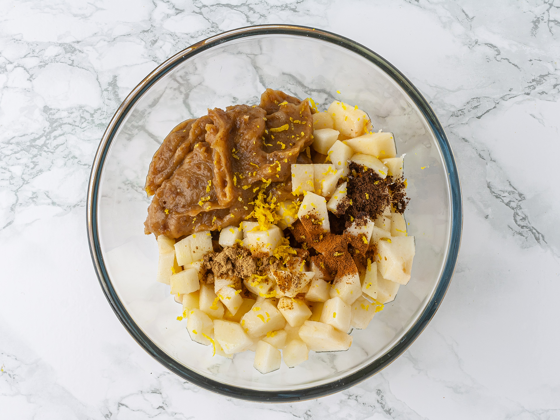 Bowl with pear turnover filling made of diced pears, dates paste, lemon zest and spices