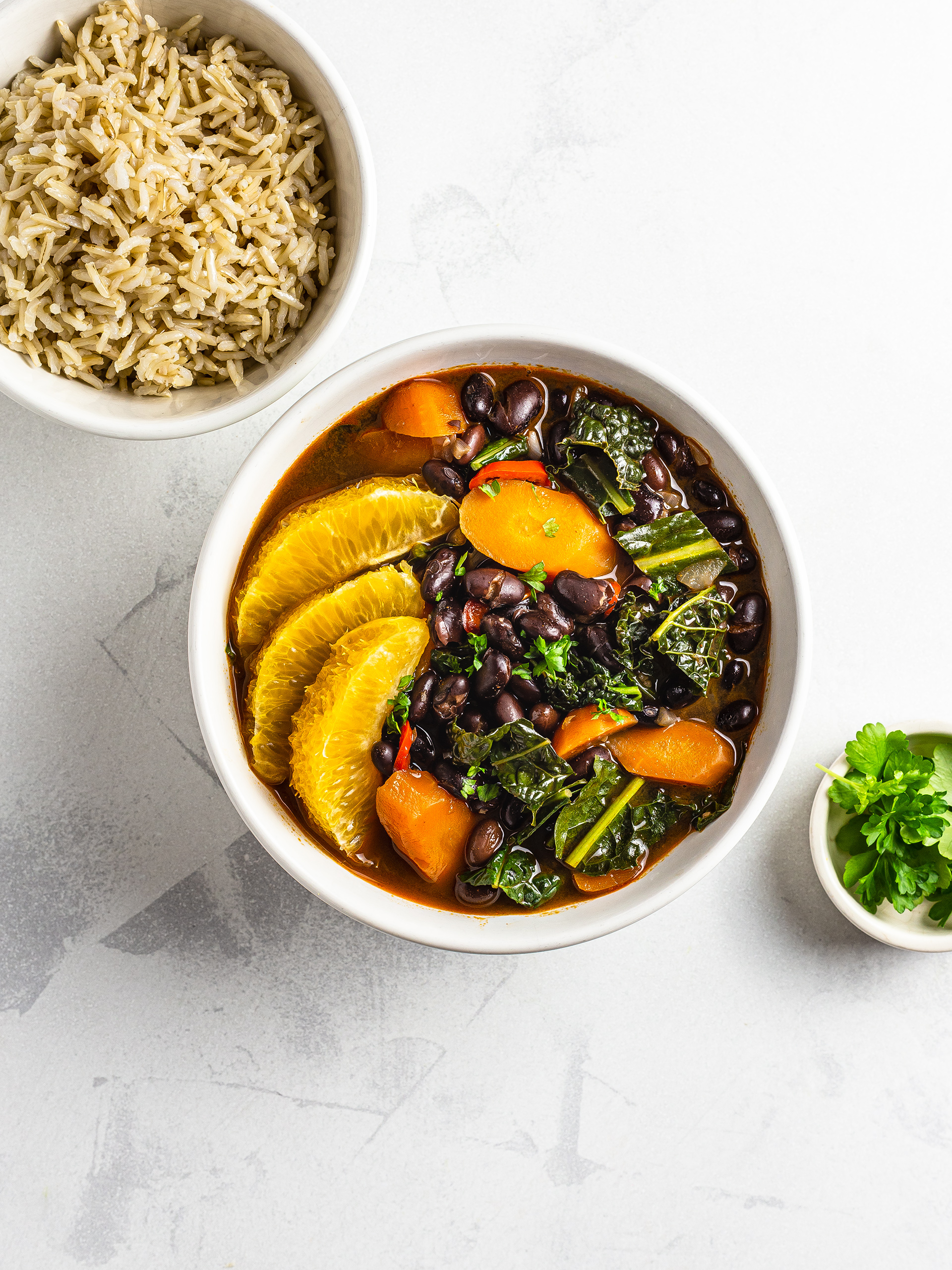 Vegan brazilian feijoada with black beans kale and carrots