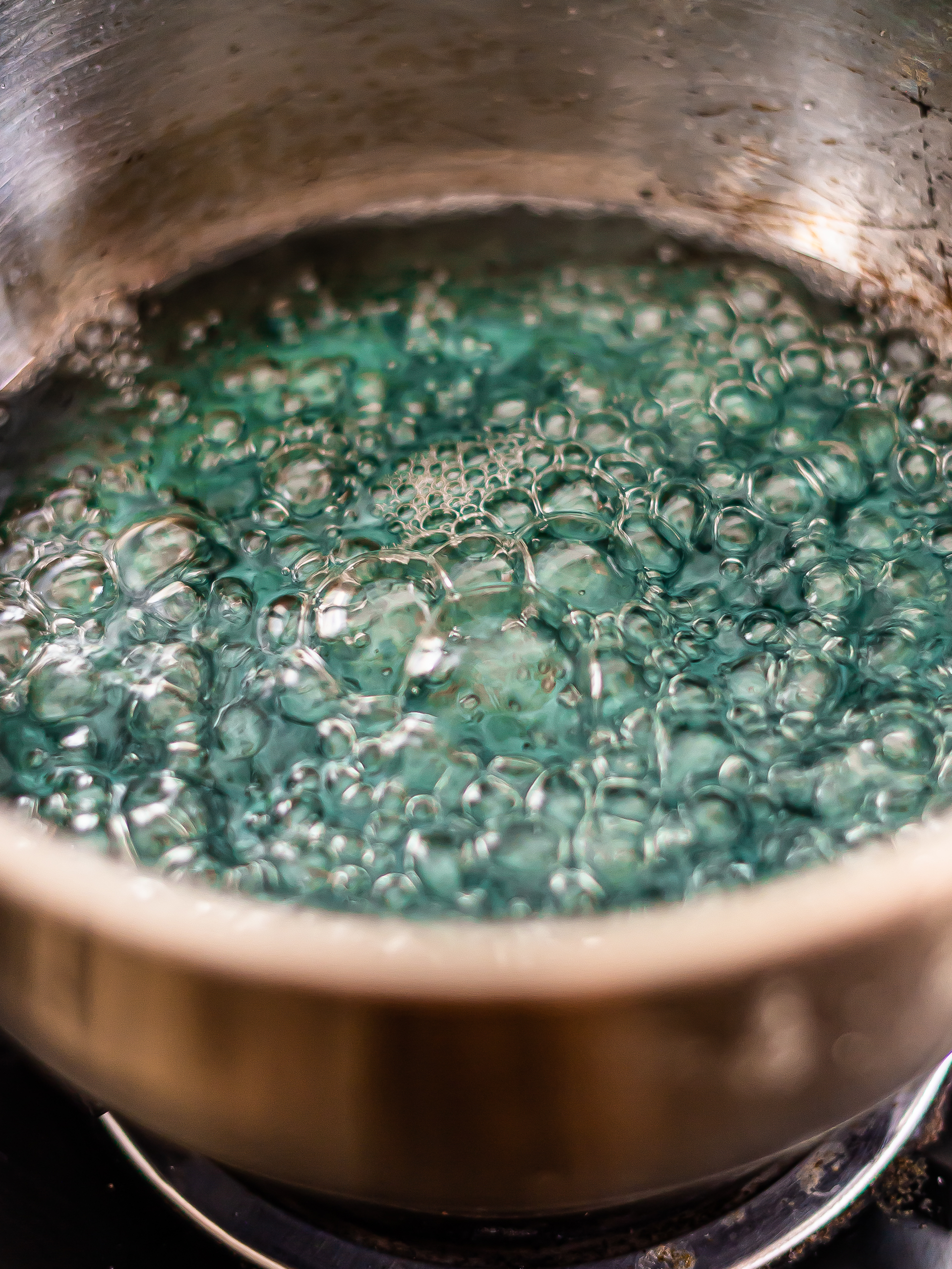 butterfly pea syrup boiling in a pot to make syrup