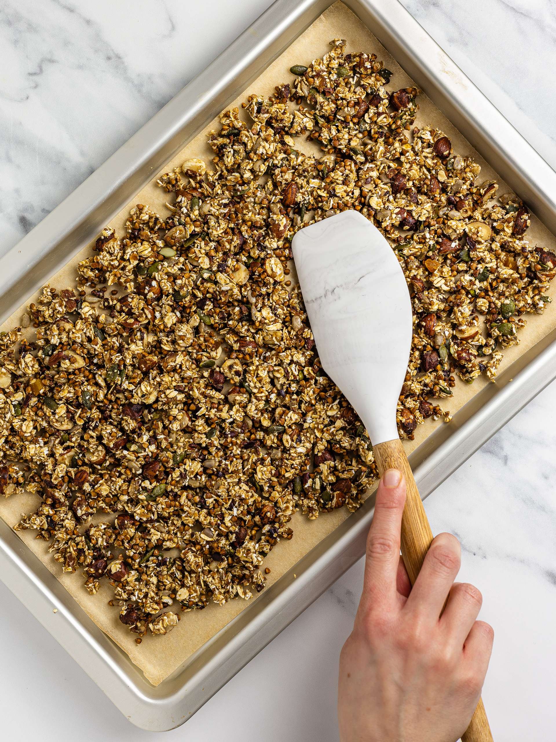 sugar-free granola spread over a baking tray