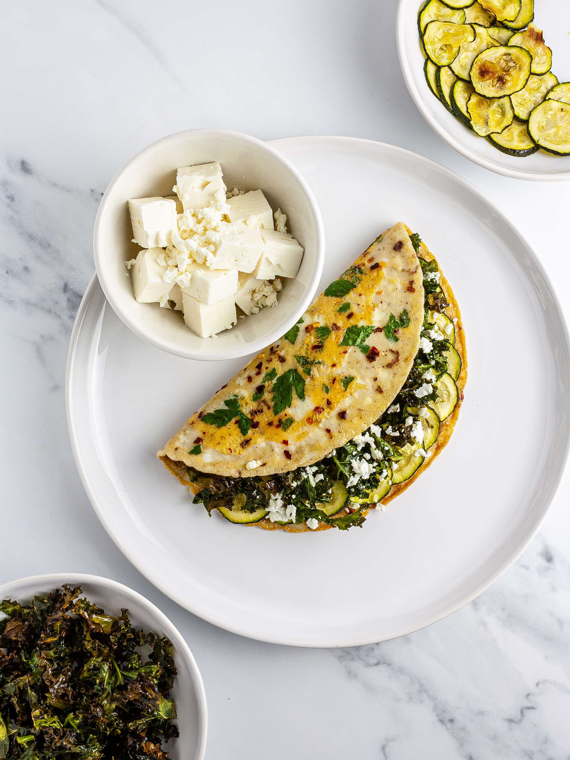 Omelette stuffed with kale, courgettes, and feta.
