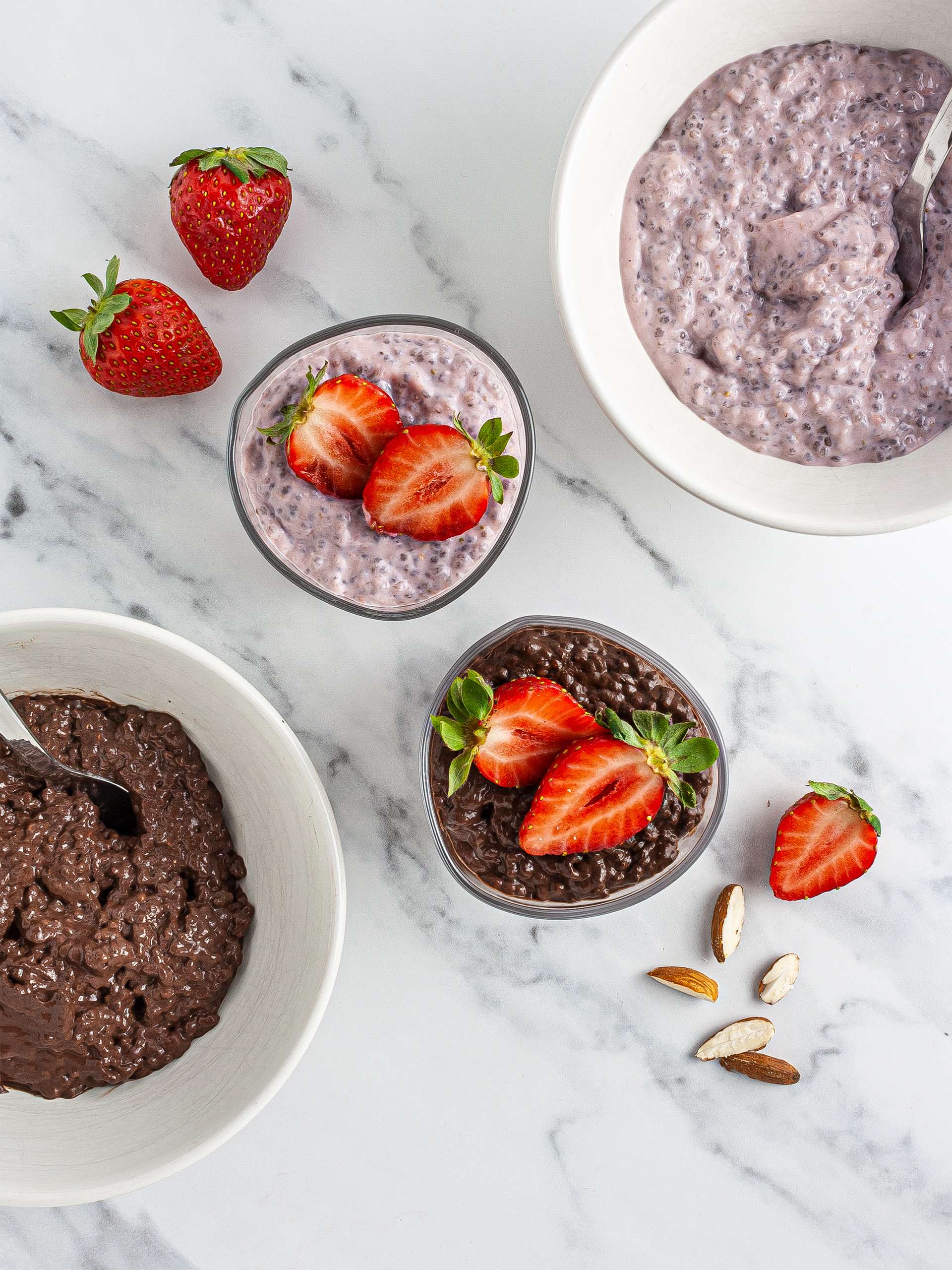 Chocolate and strawberry pudding served in glasses with almonds and fresh strawberries