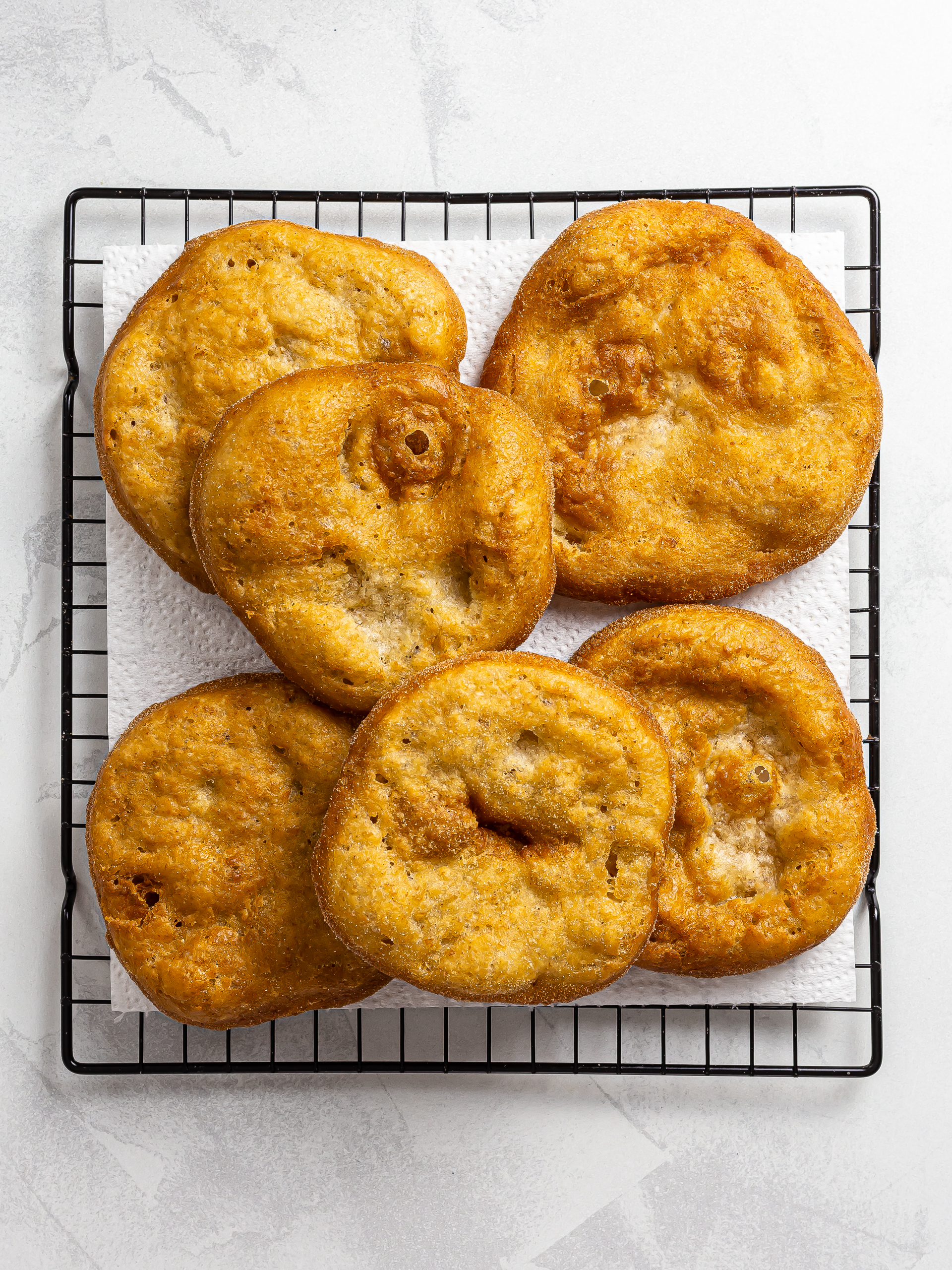 fried sourdough fry bread discs on a rack