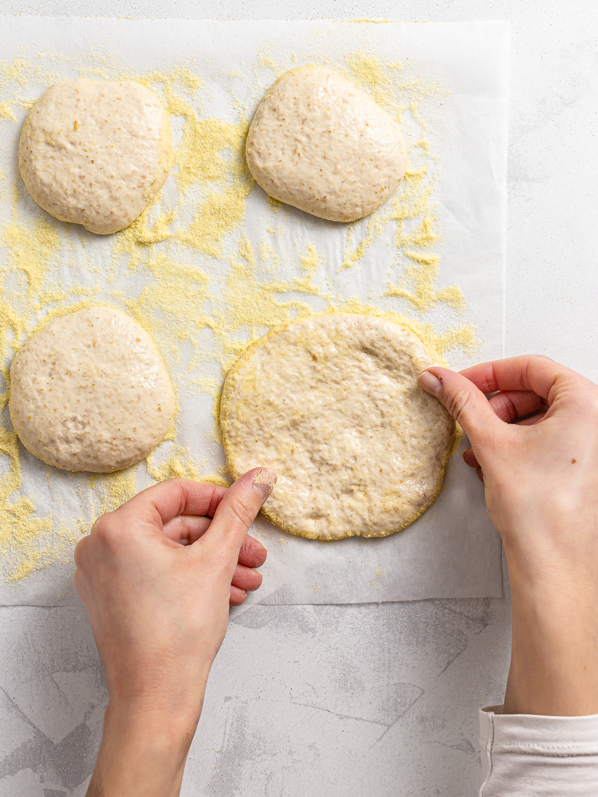 woman shaping fry bread discs