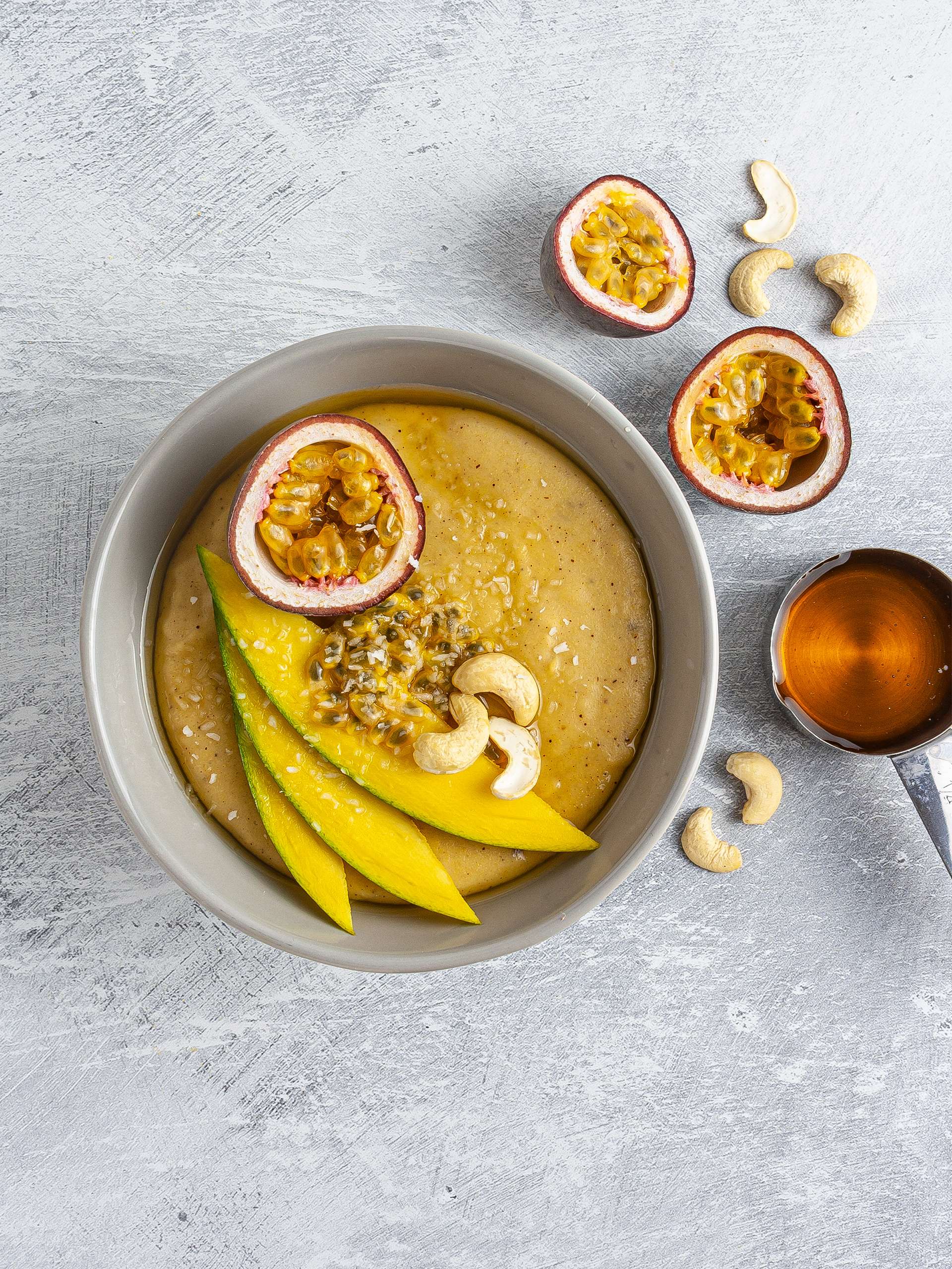 Cornmeal porridge topped with passion, fruit, mango, cashews, and maple