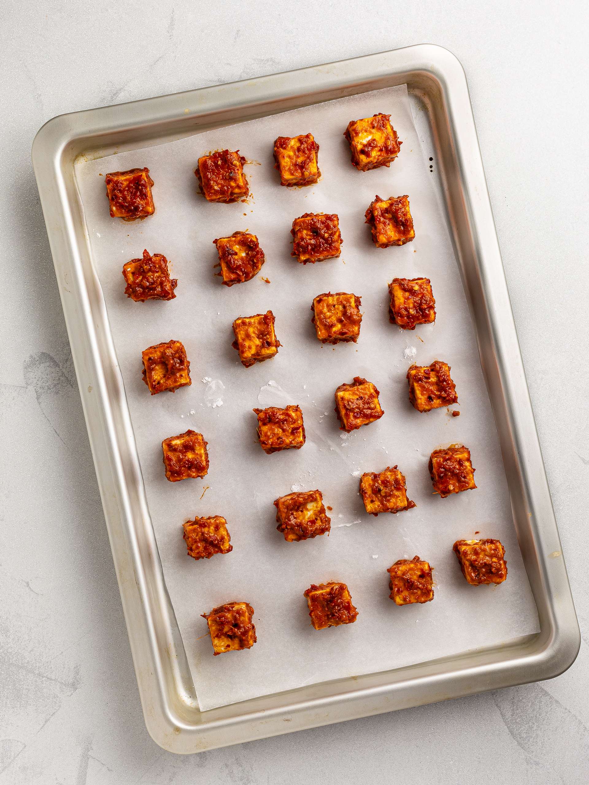 tofu bites with firecracker sauce on a baking tray