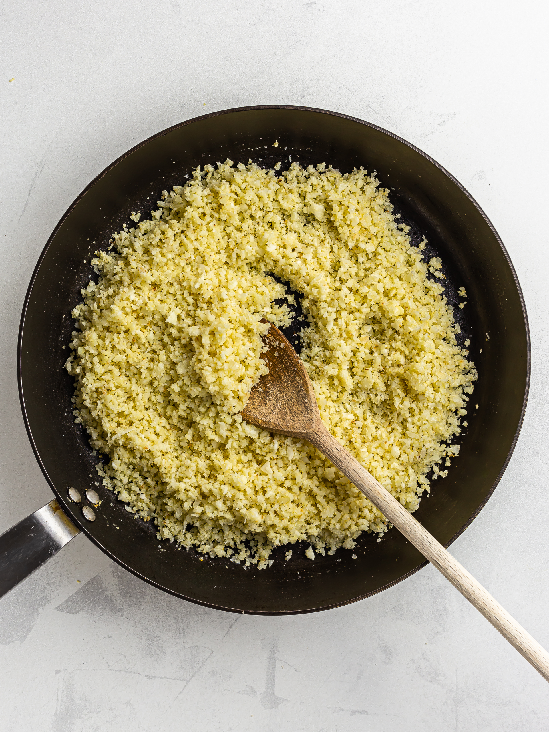 cooked cauliflower rice in a skillet