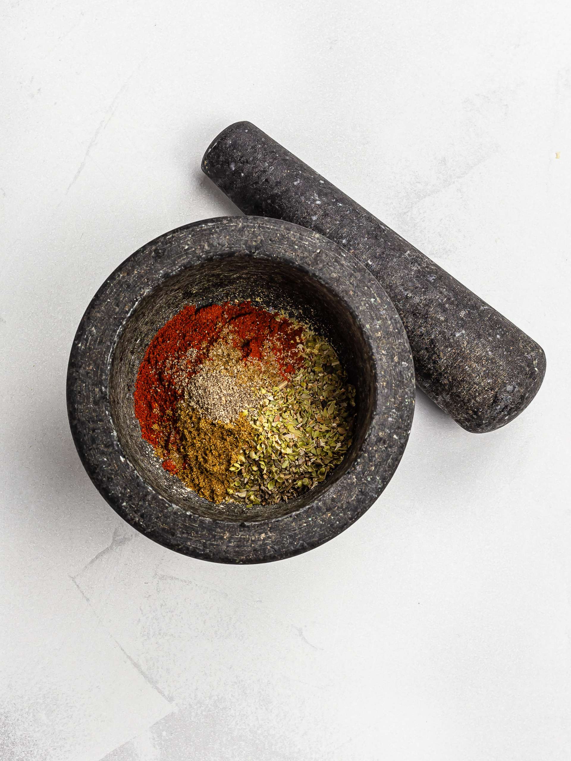 red robin seasoning ingredients in a mortar