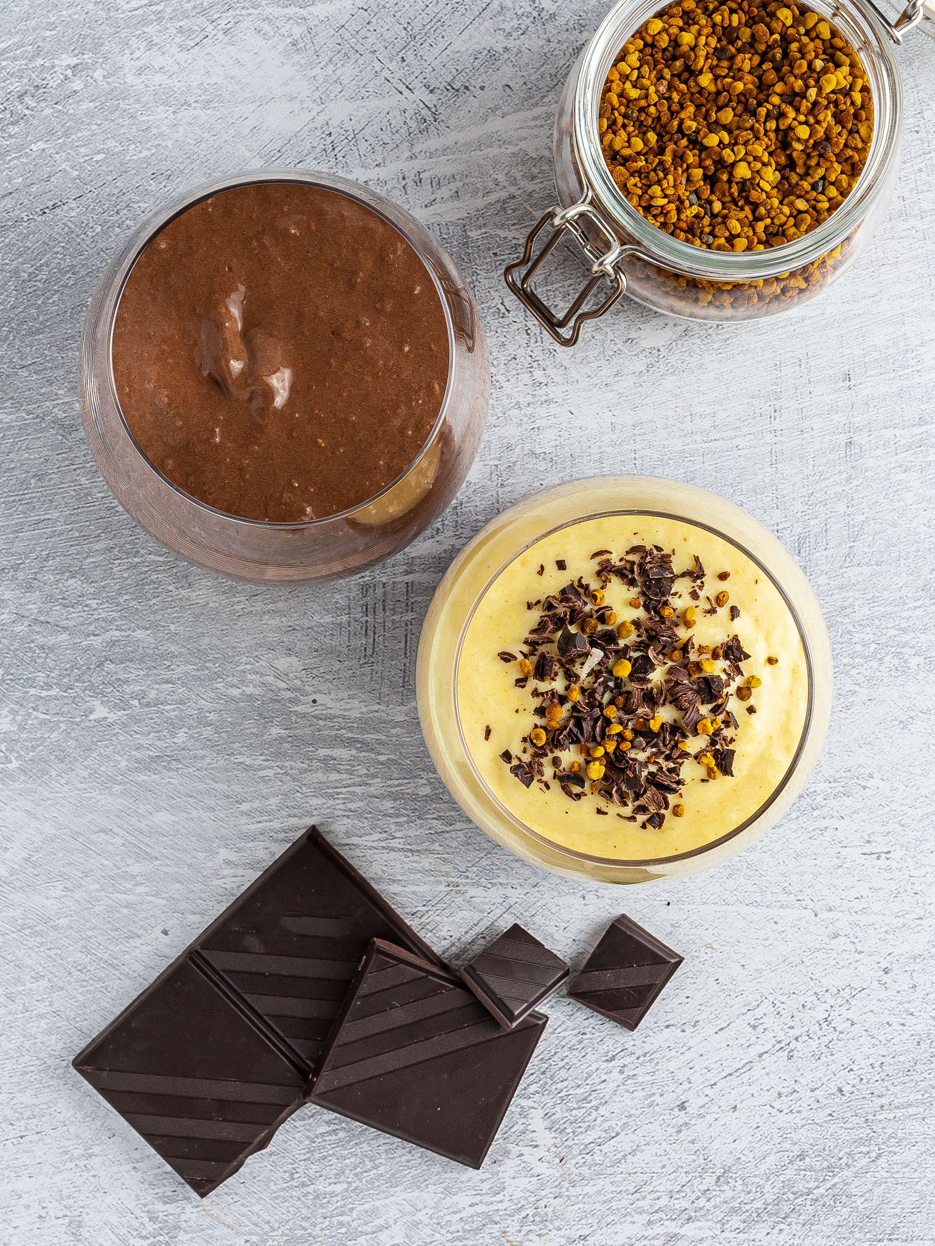 Chocolate mango smoothie in serving glass with bee pollen.