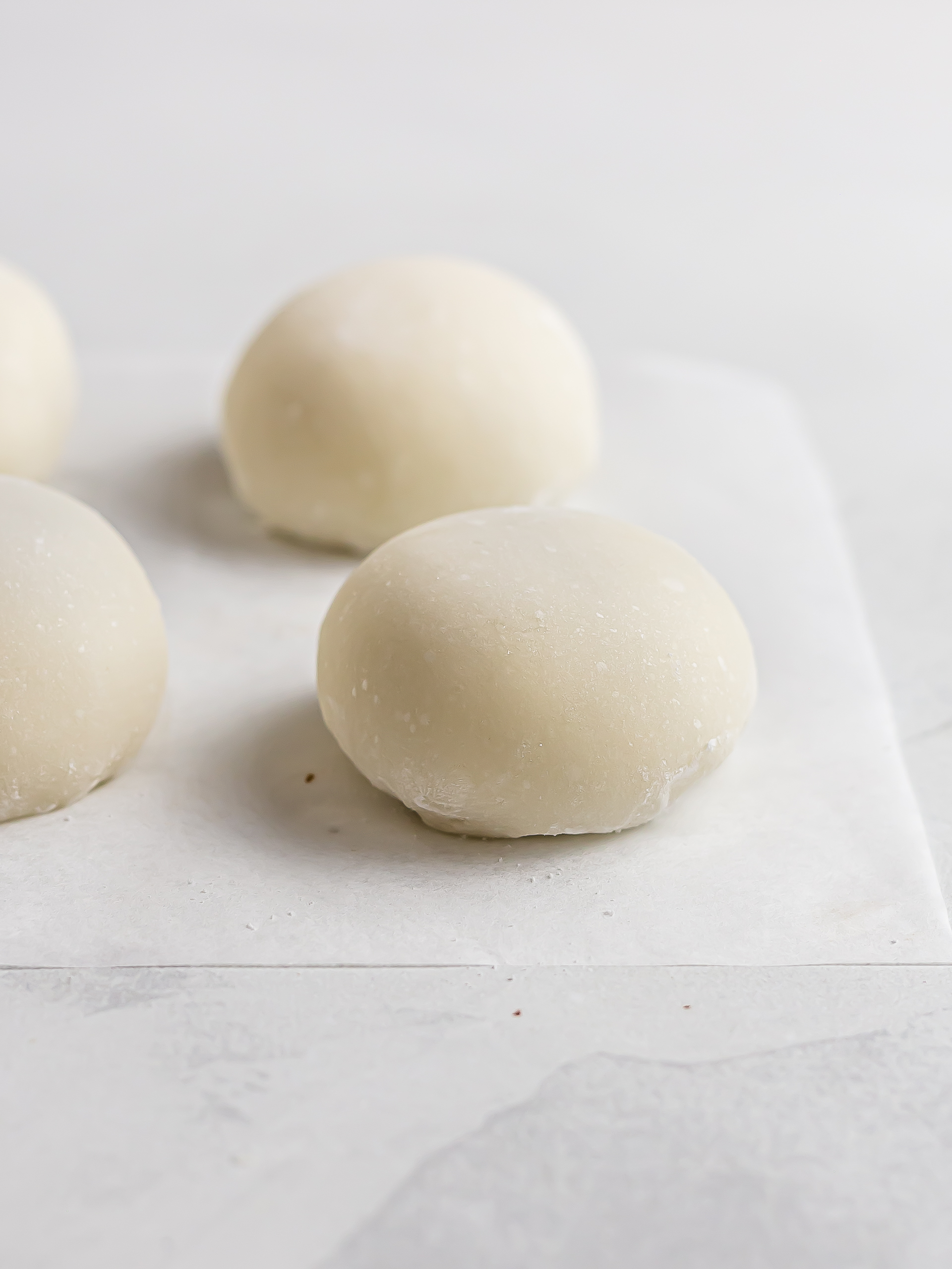 shaped mochi balls on a sheet of baking paper