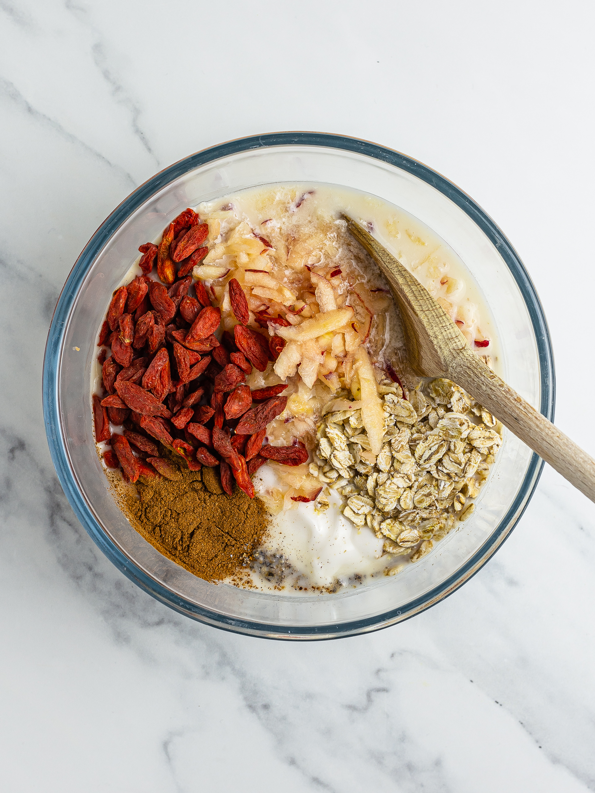 Goji, apple, and cinnamon muesli ingredients in a bowl