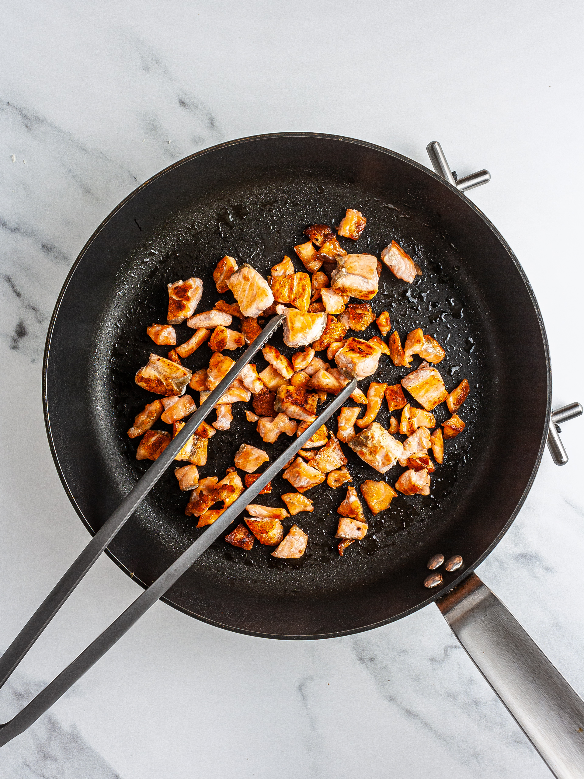 Cooked salmon fillet in a skillet.