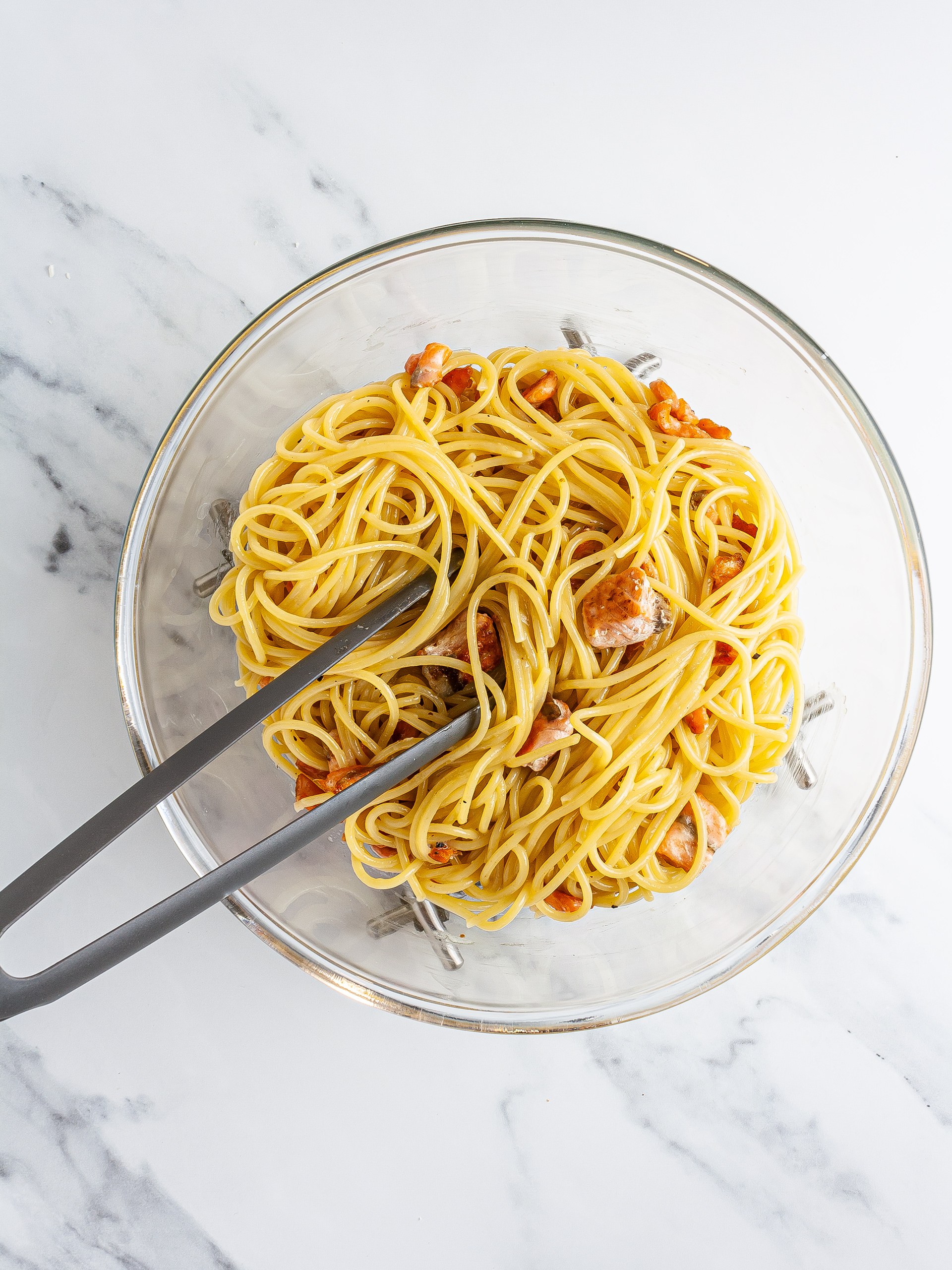 Spaghetti pasta mixed with beaten eggs and salmon