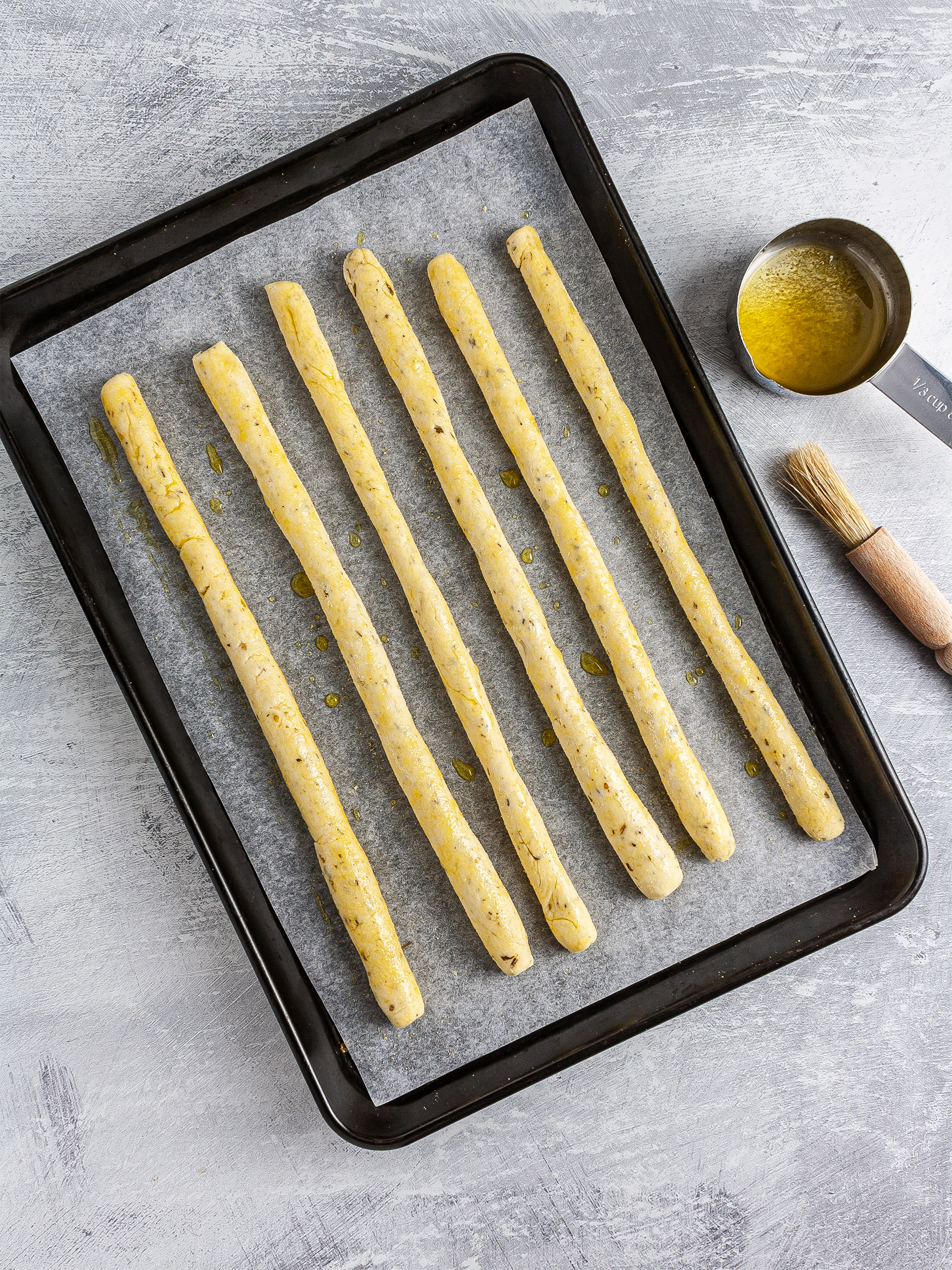 Proved breadsticks brushed with oil