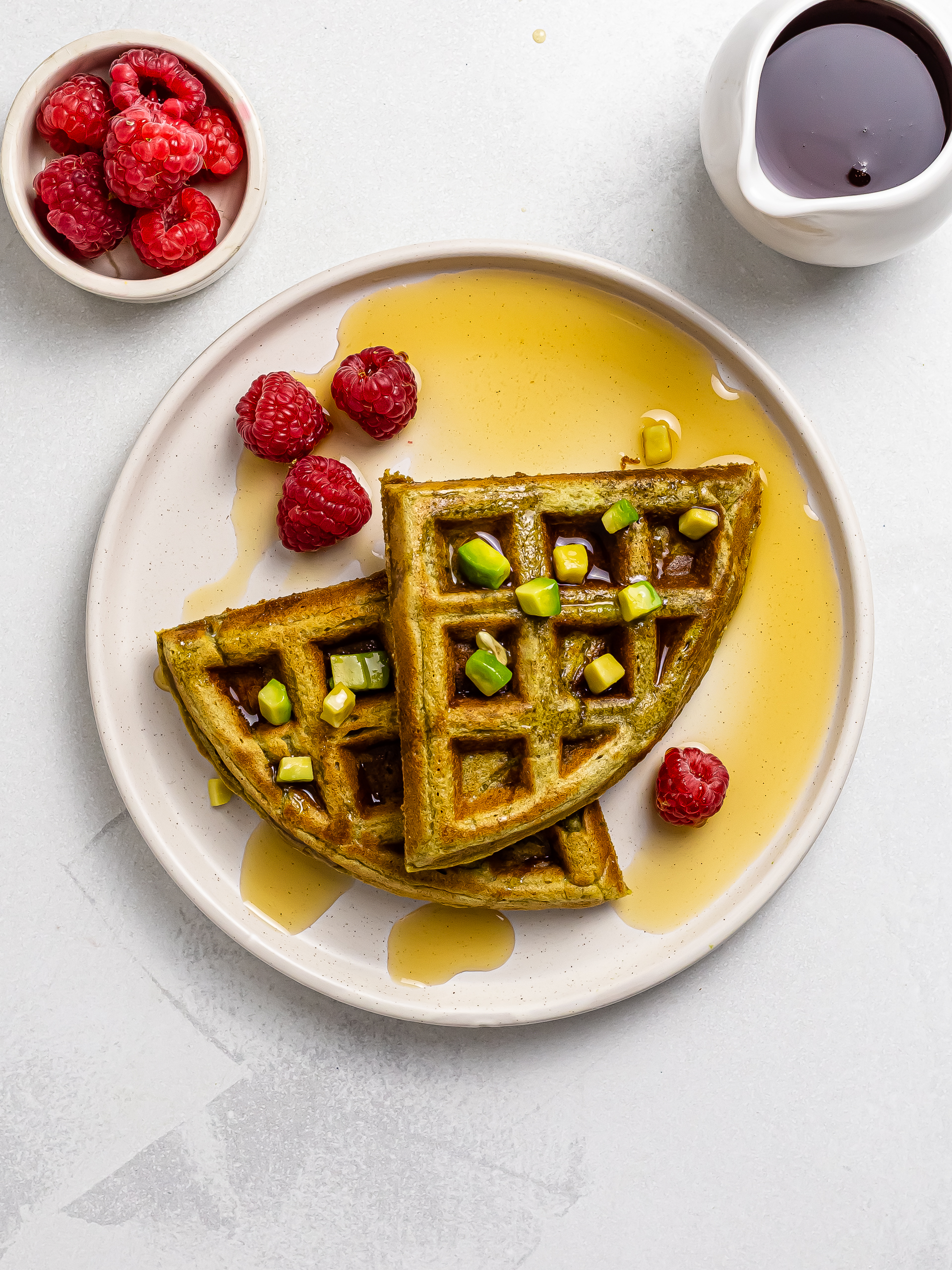 avocado waffles on a plate with berries