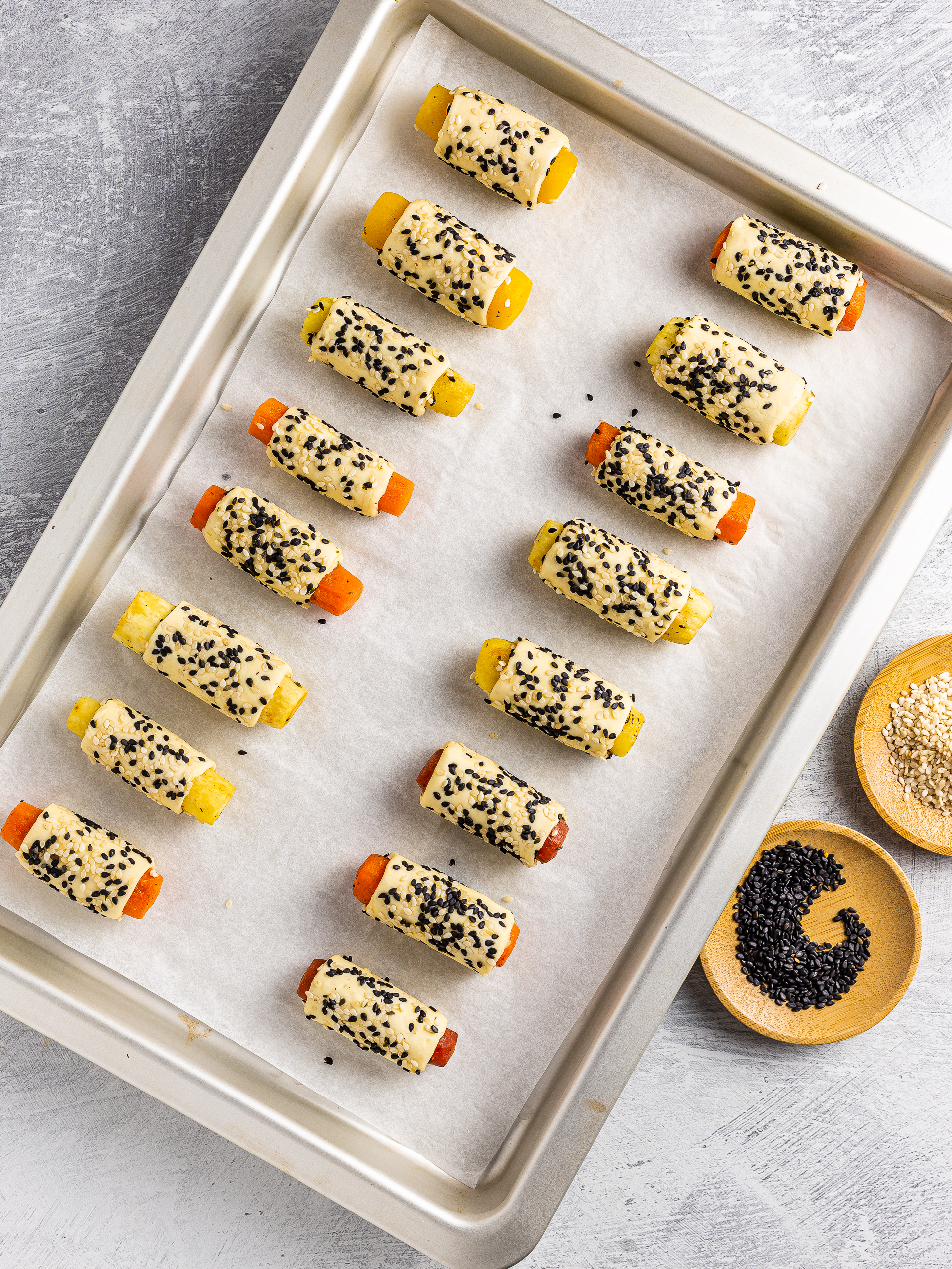 carrots pigs in a blanket pastries with sesame seeds