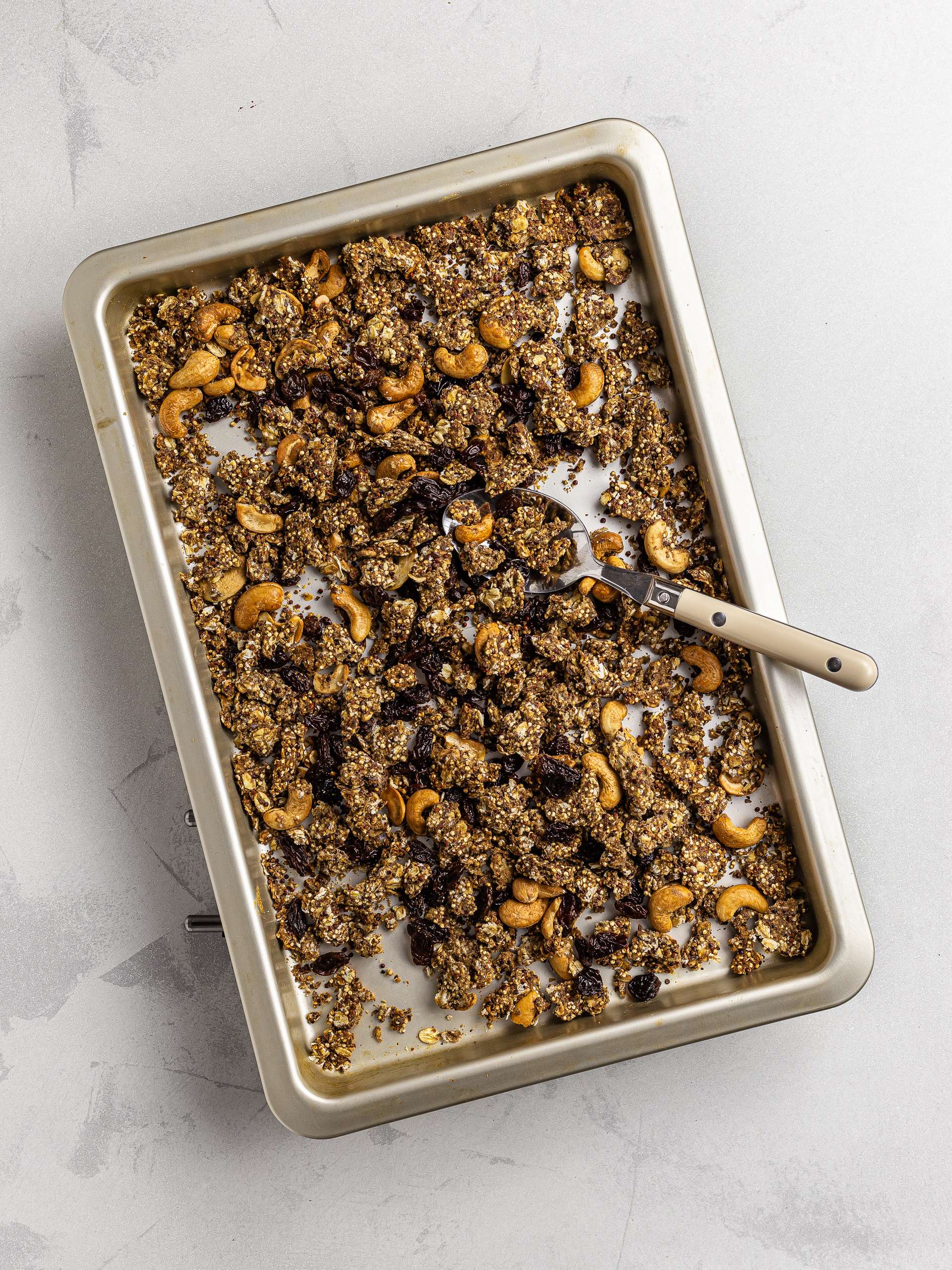 cashew granola with raisins on a baking tray
