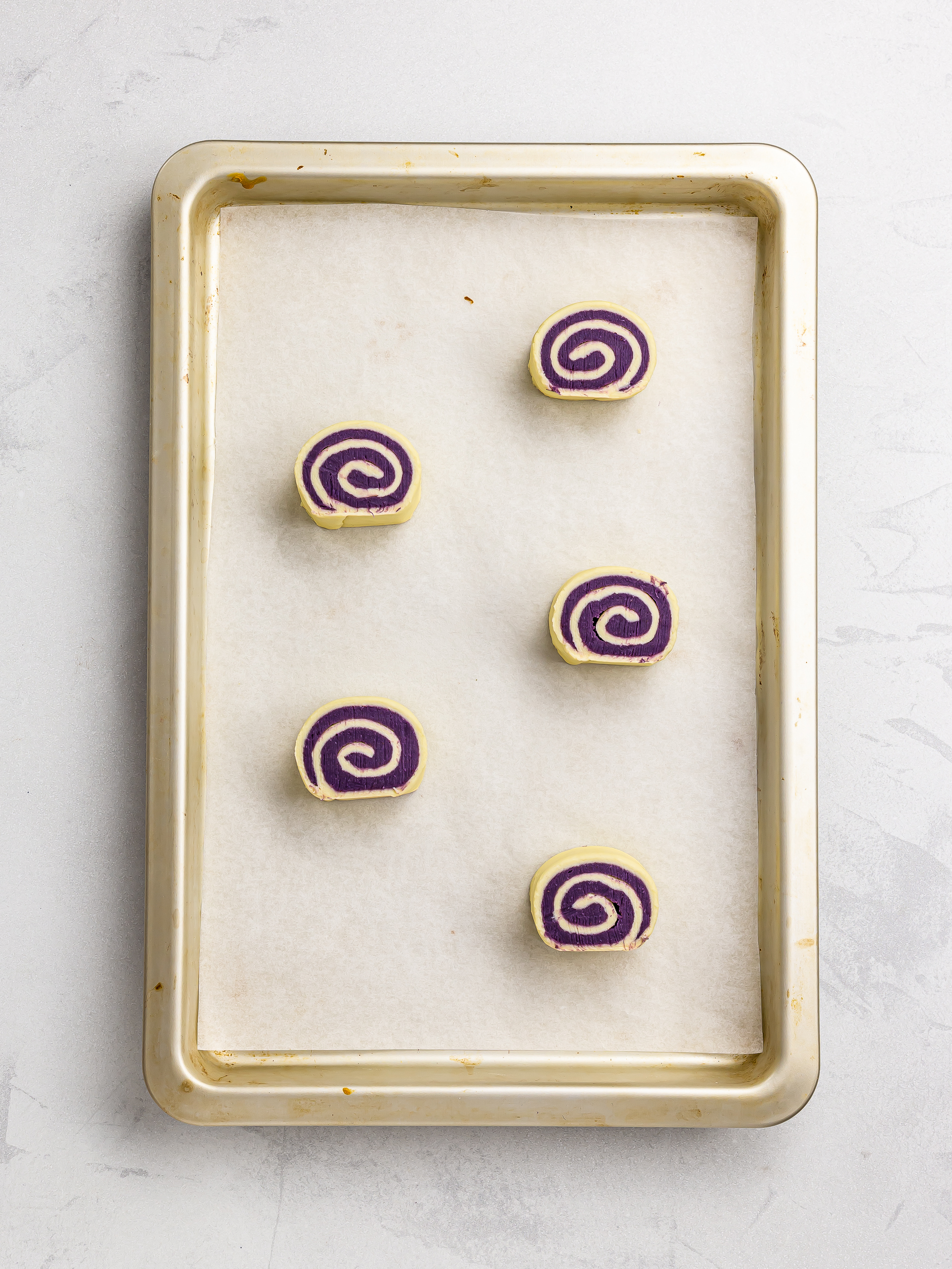 ube cinnamon rolls on a baking tray