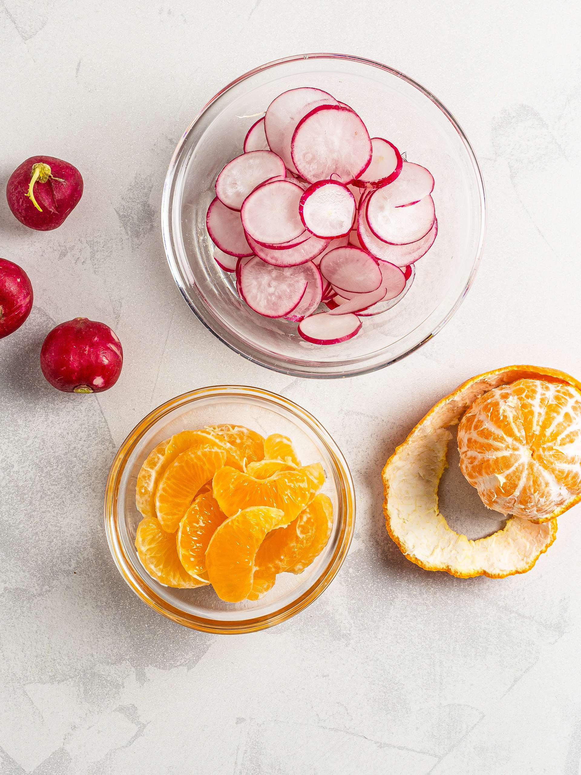 Sliced radishes and tangerines