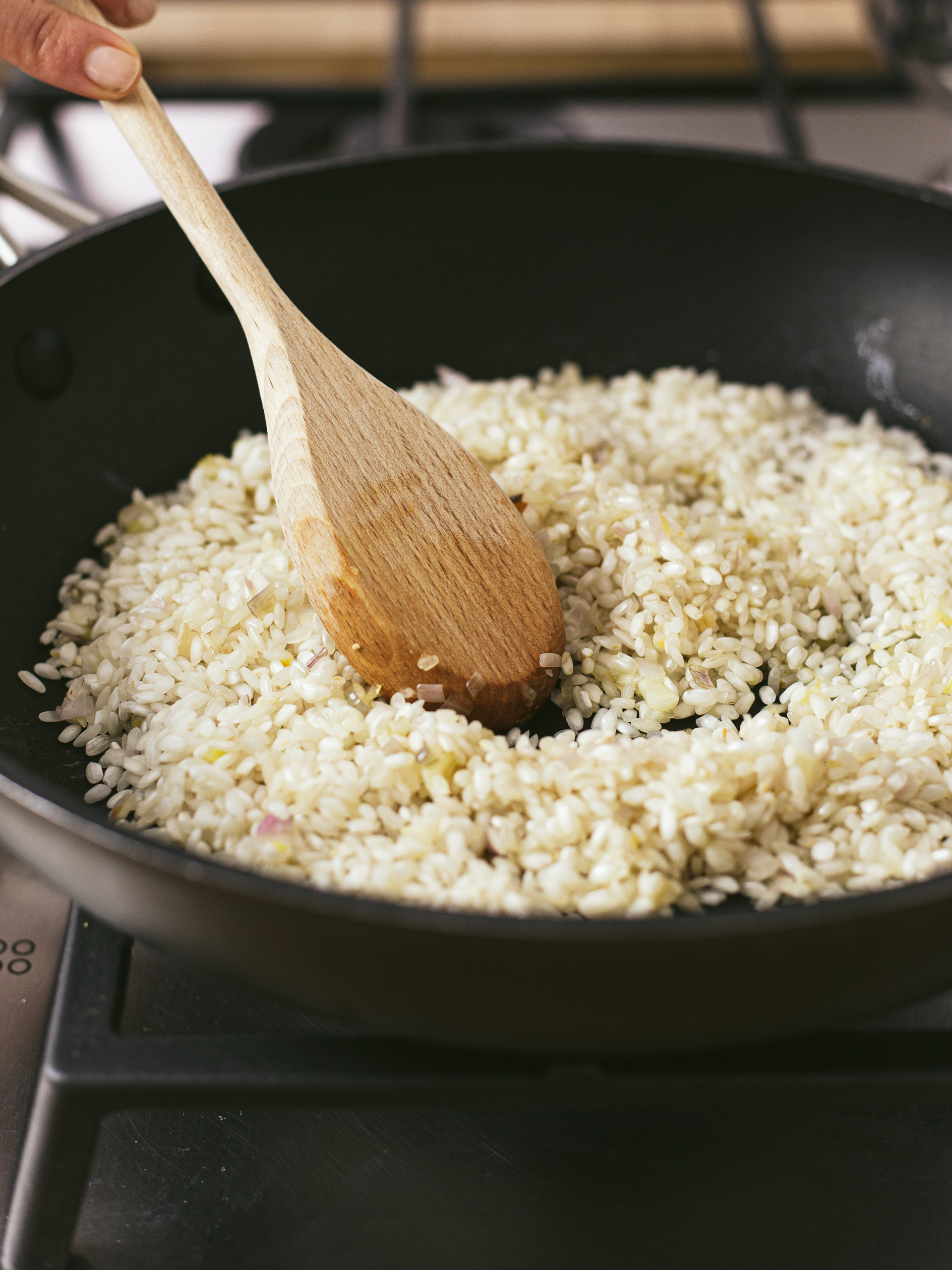 risotto rice dry cooking in a skillet