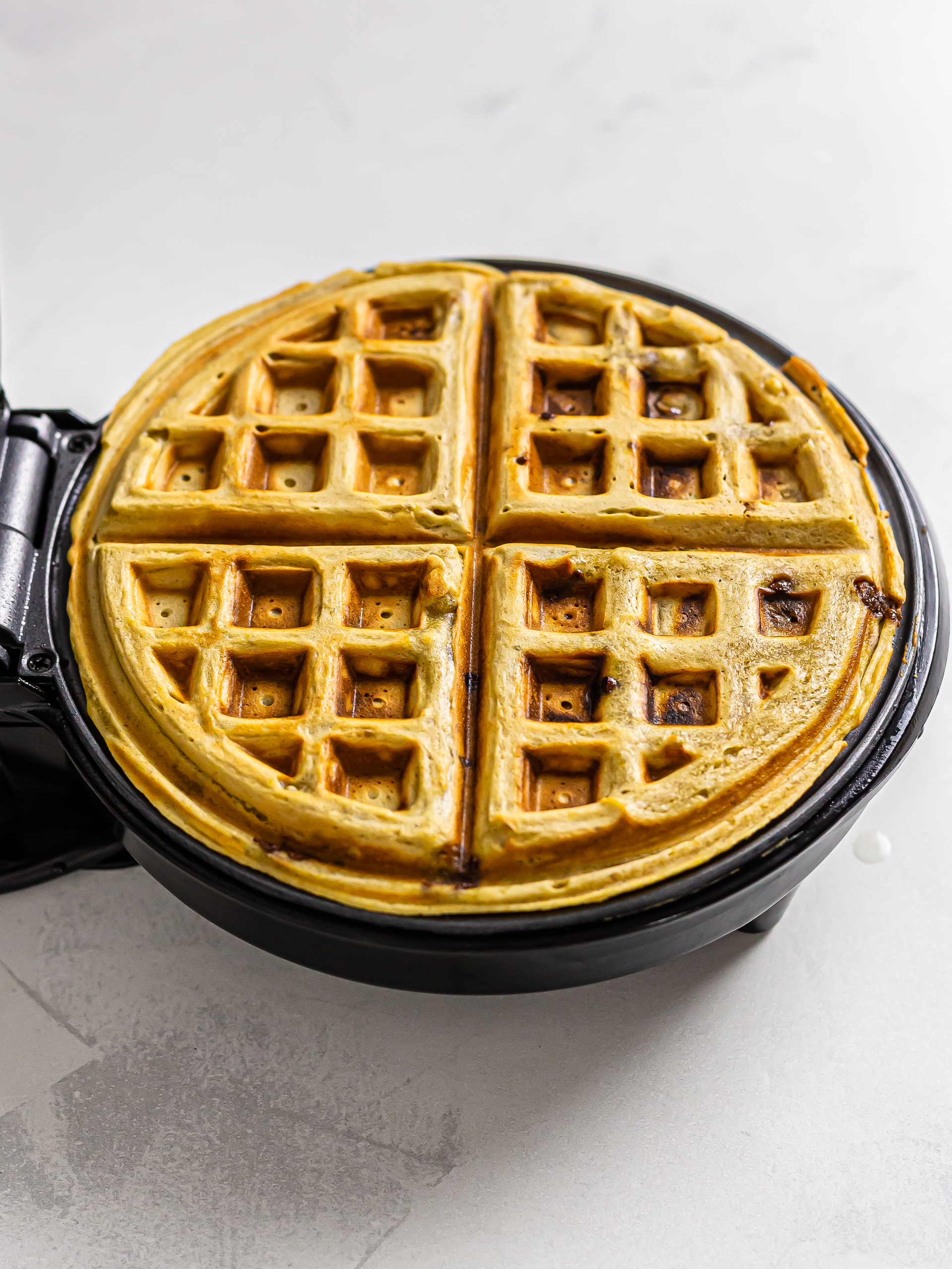 plantain banana waffle cooking in a waffle machine