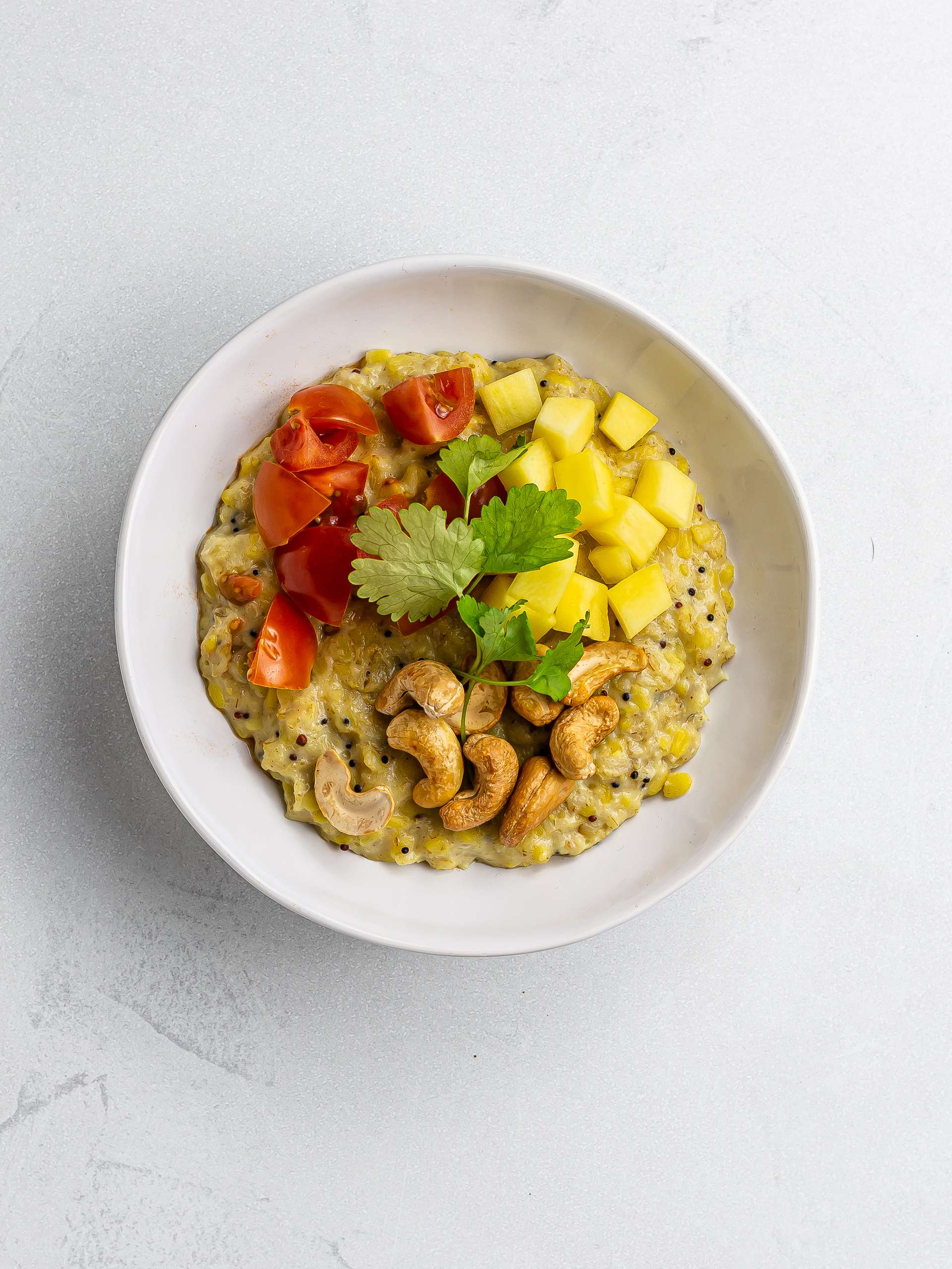 curry porridge with chopped mangos and tomatoes