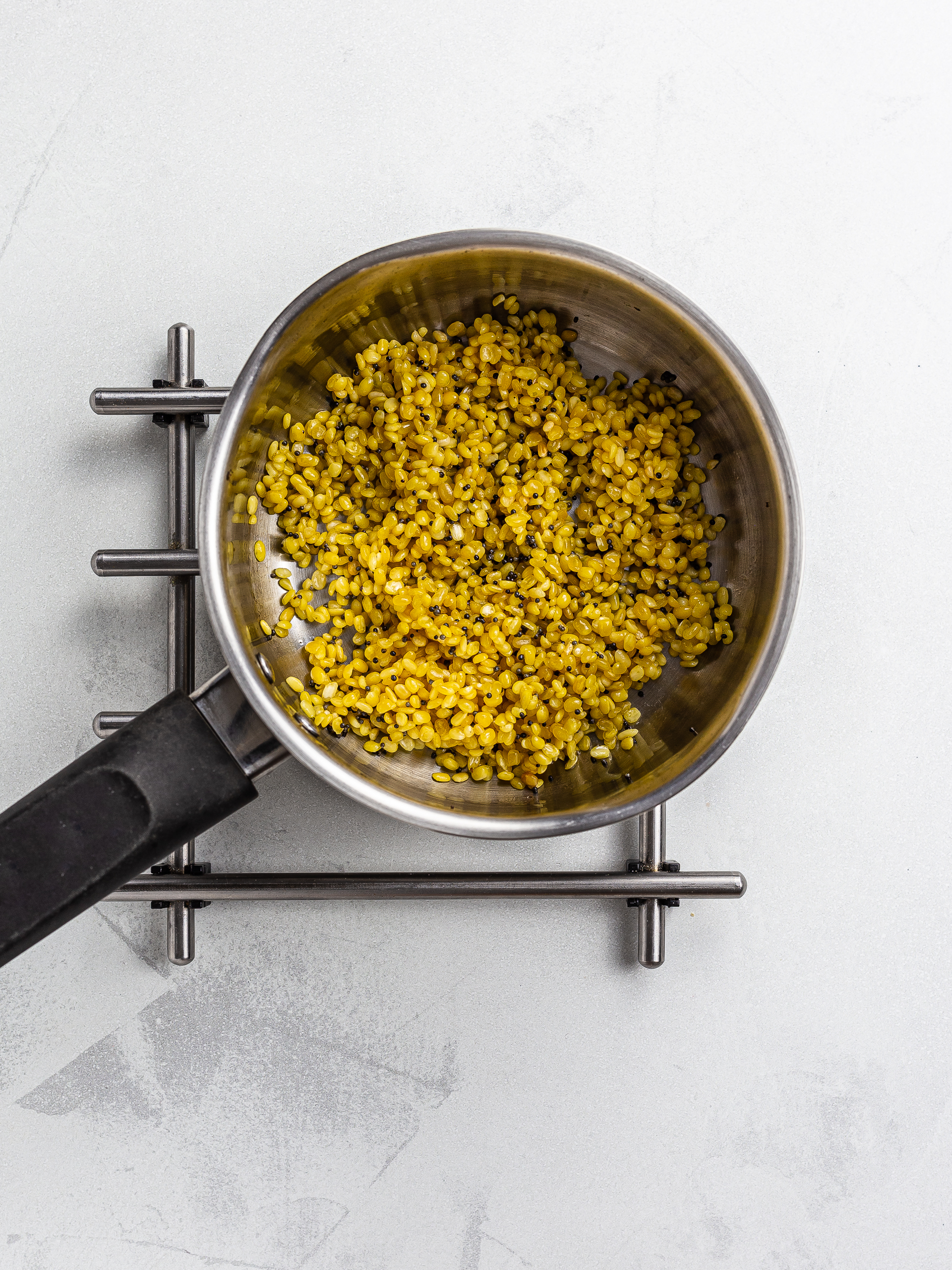 mustard seeds with mung dal in a pot