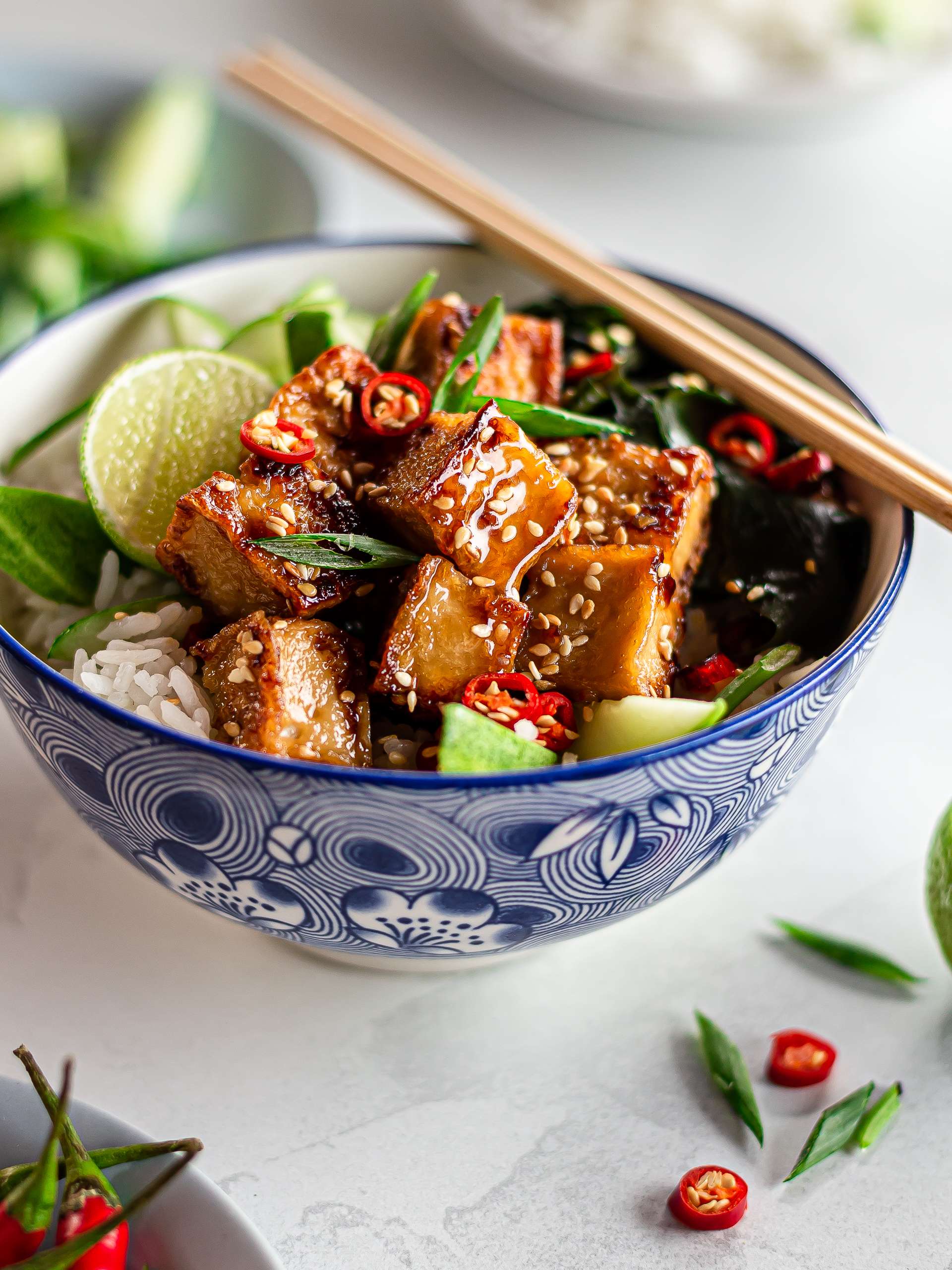 spicy honey glazed tofu in a bowl with rice and veggies