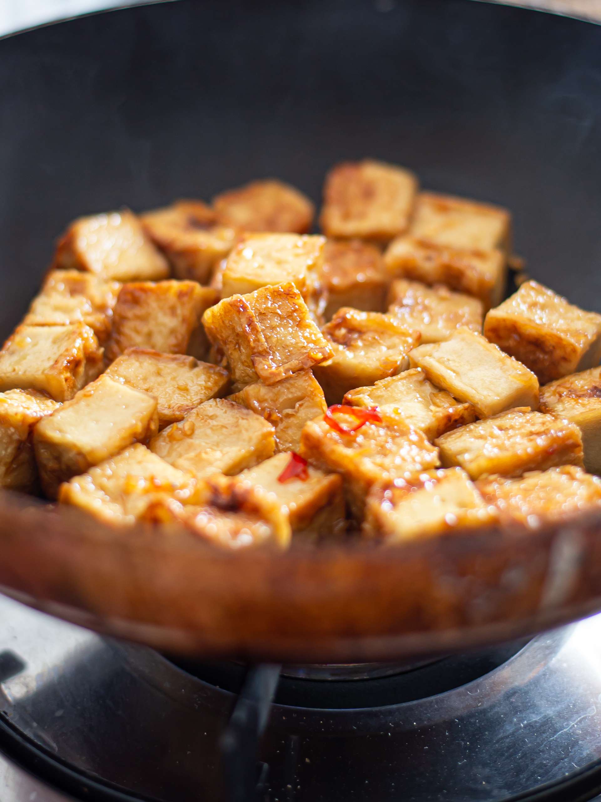 tofu coated with garlic honey glaze in a pan