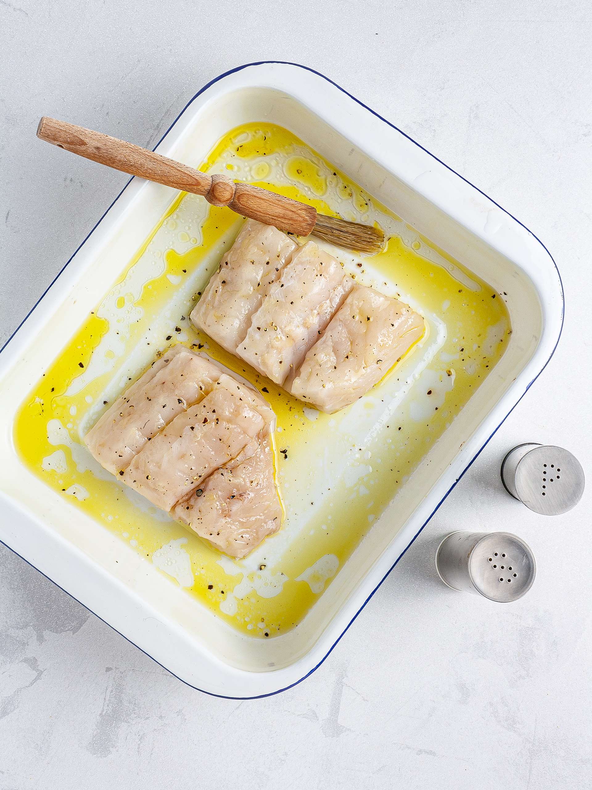 Hake fillet brushed with oil and seasoned with salt and pepper