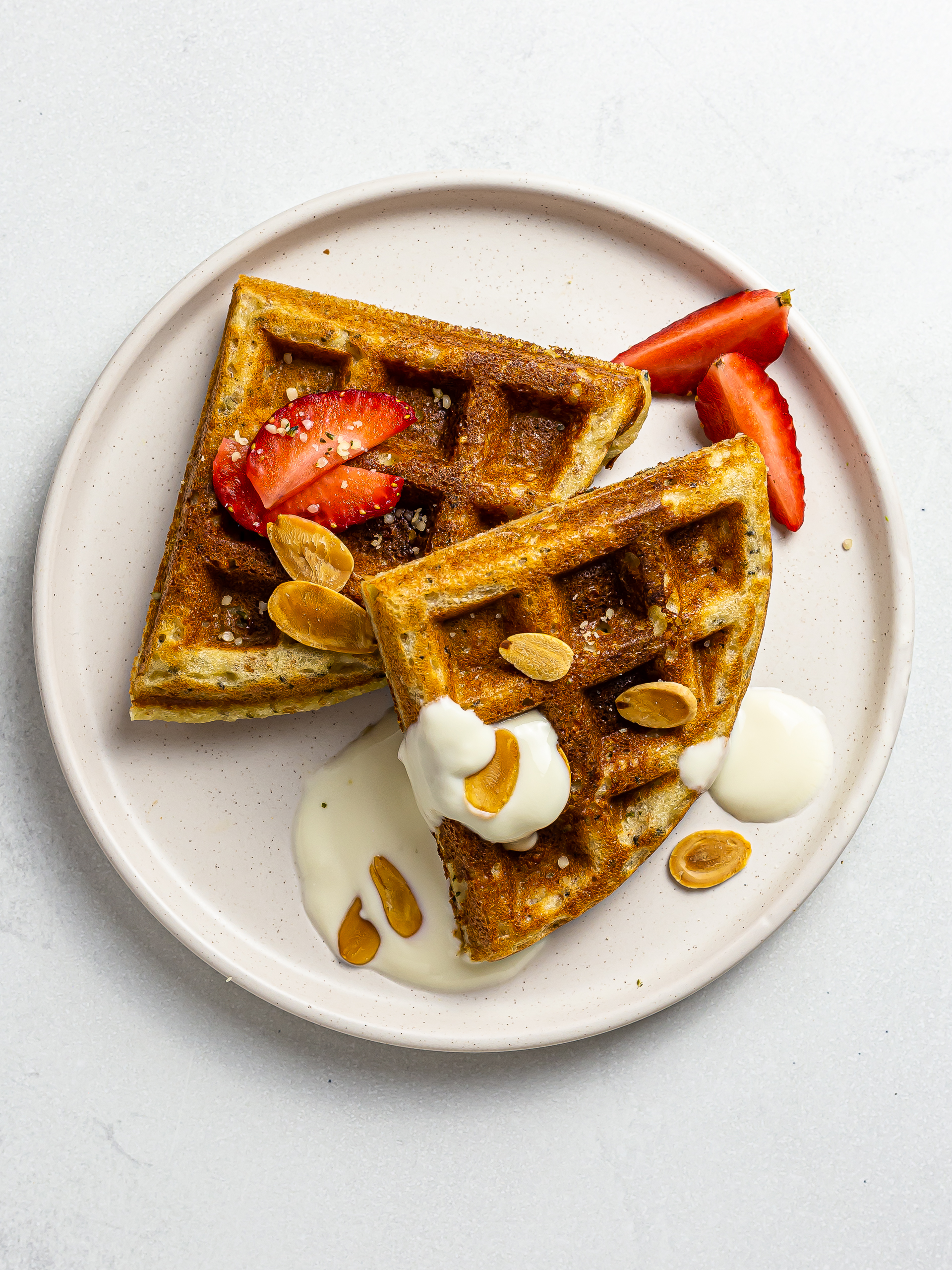 vegan protein waffles on a plate with yogurt and berries