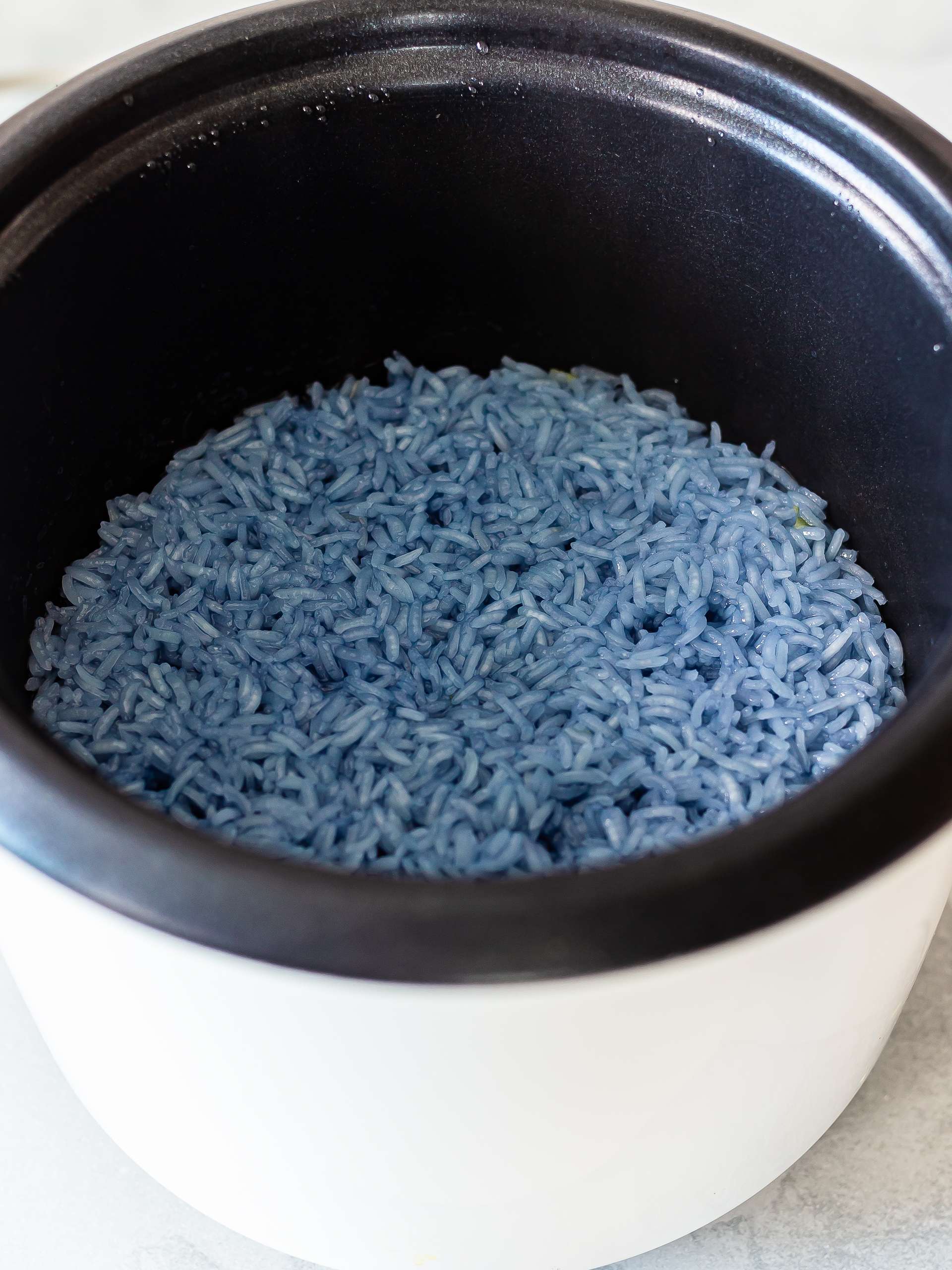 cooked blue sticky rice in a rice cooker
