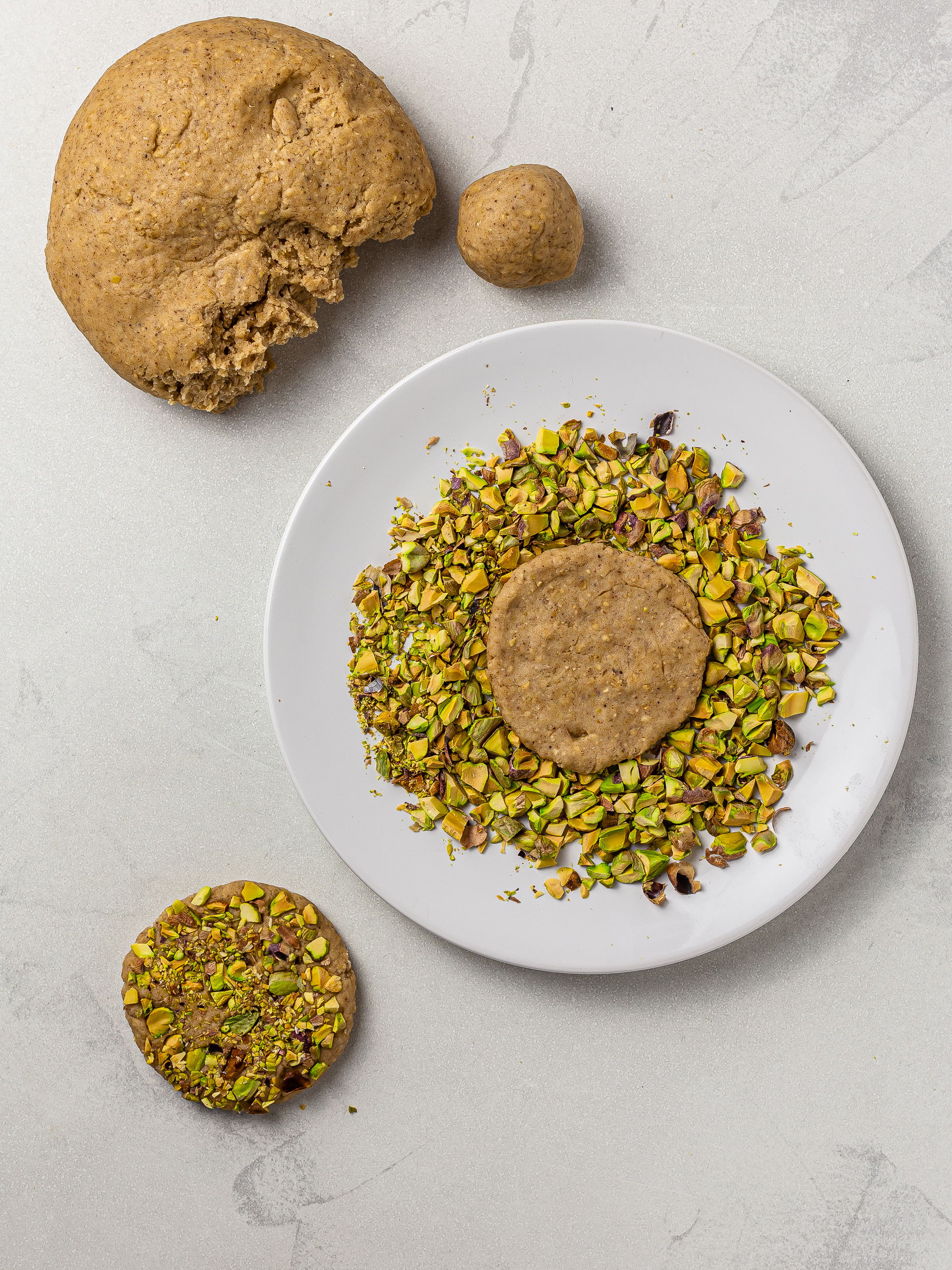 tahini cookies coated with chopped pistachios