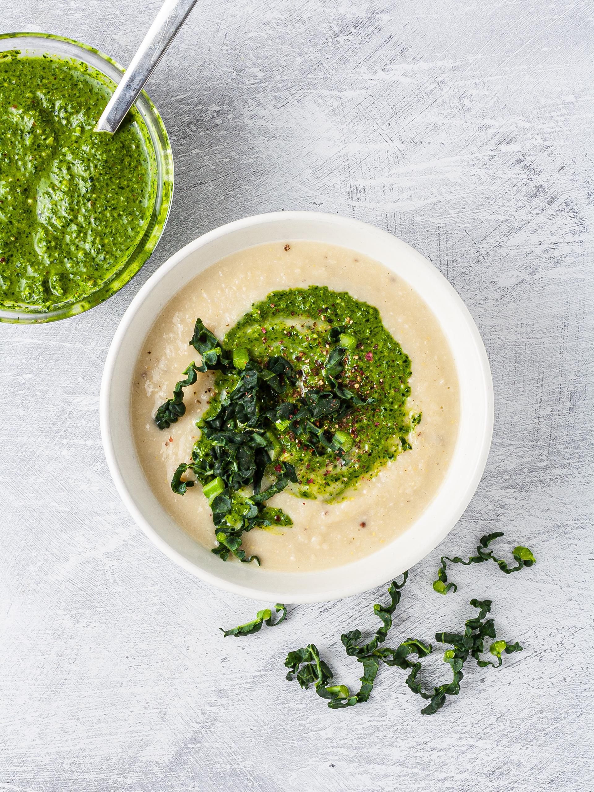 White bean soup in a bowl with kale pesto