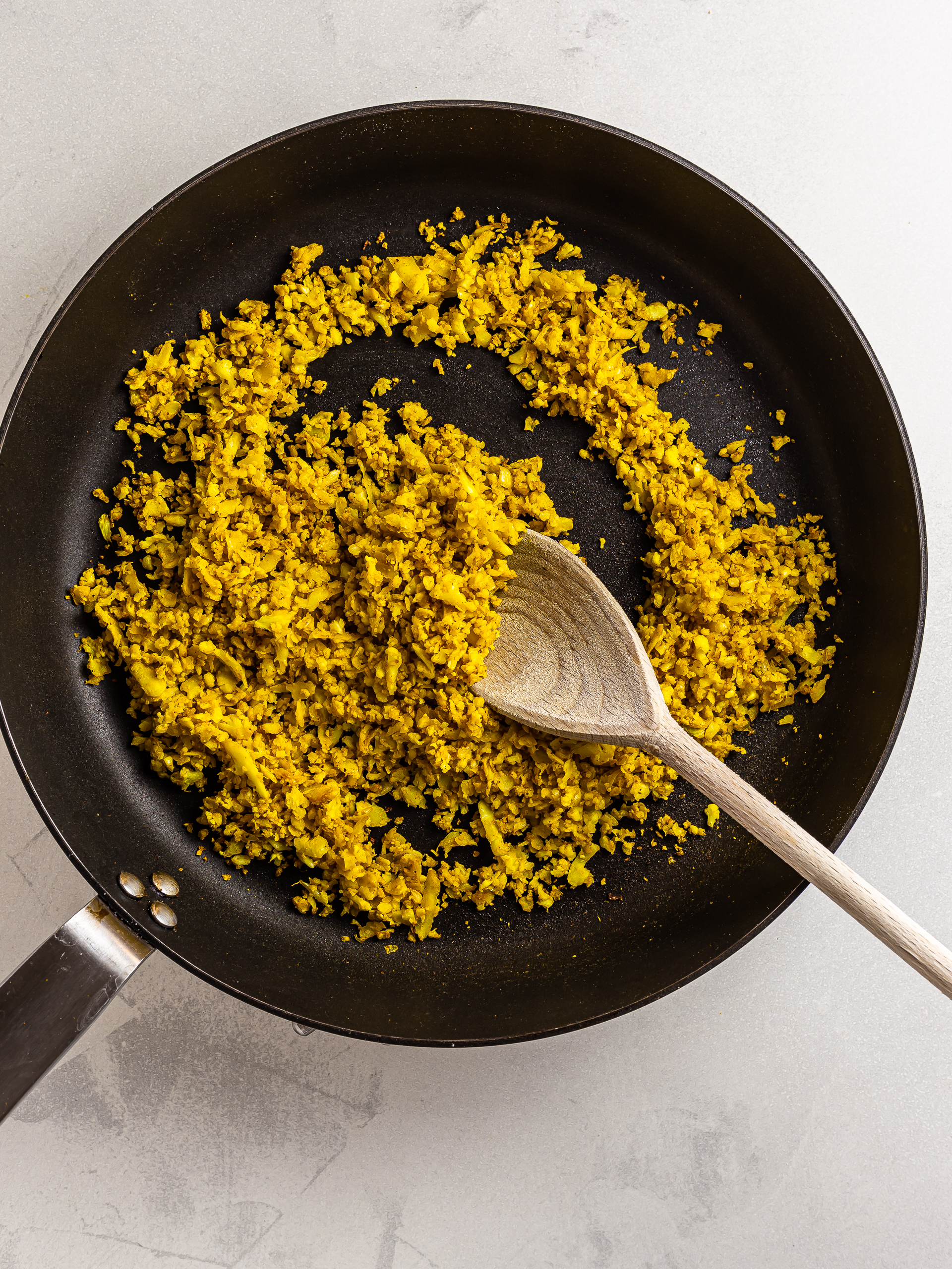 Cauliflower scramble with turmeric in a skillet