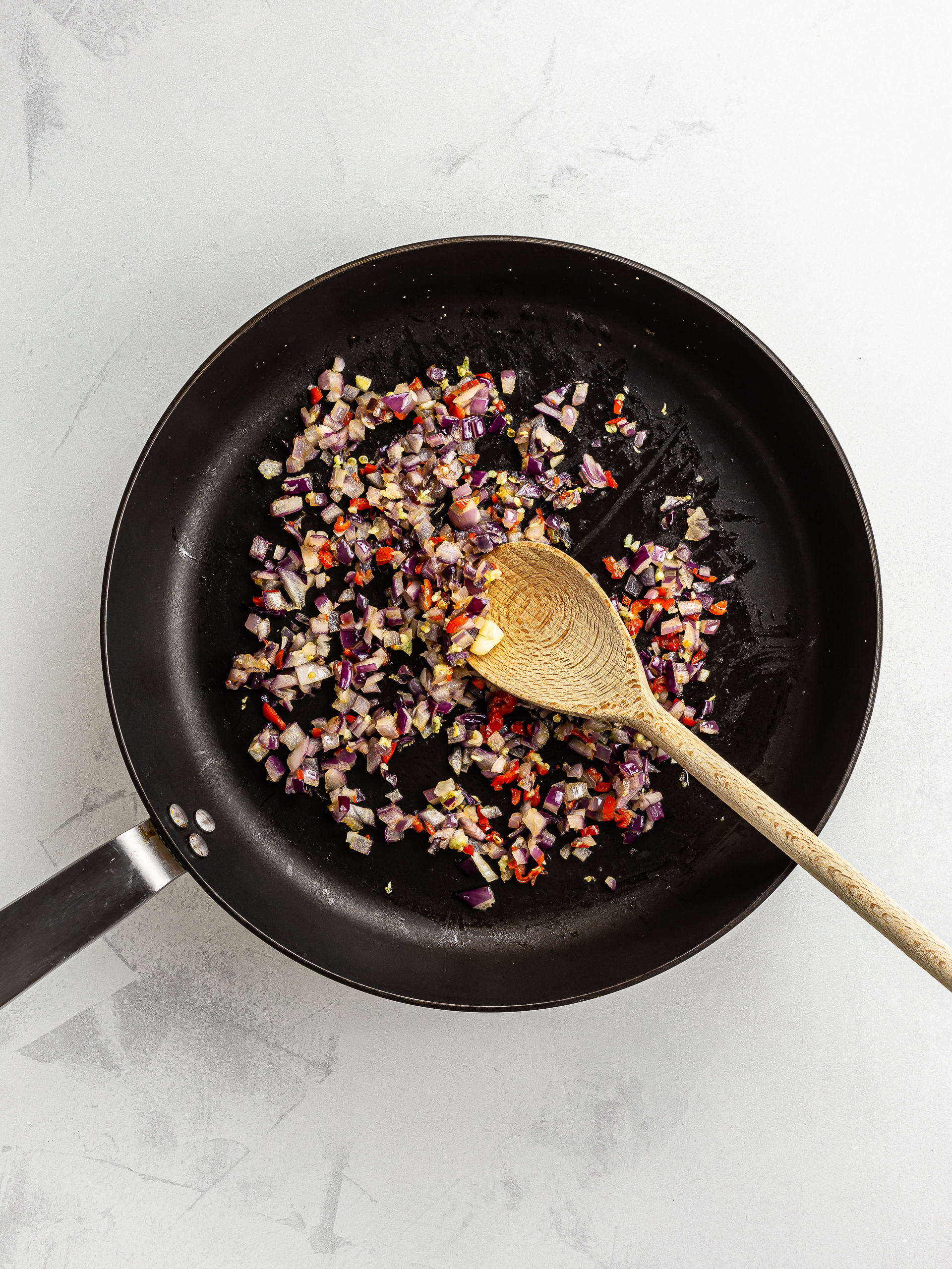 onions and scotch bonnet chillies sizzled in a skillet