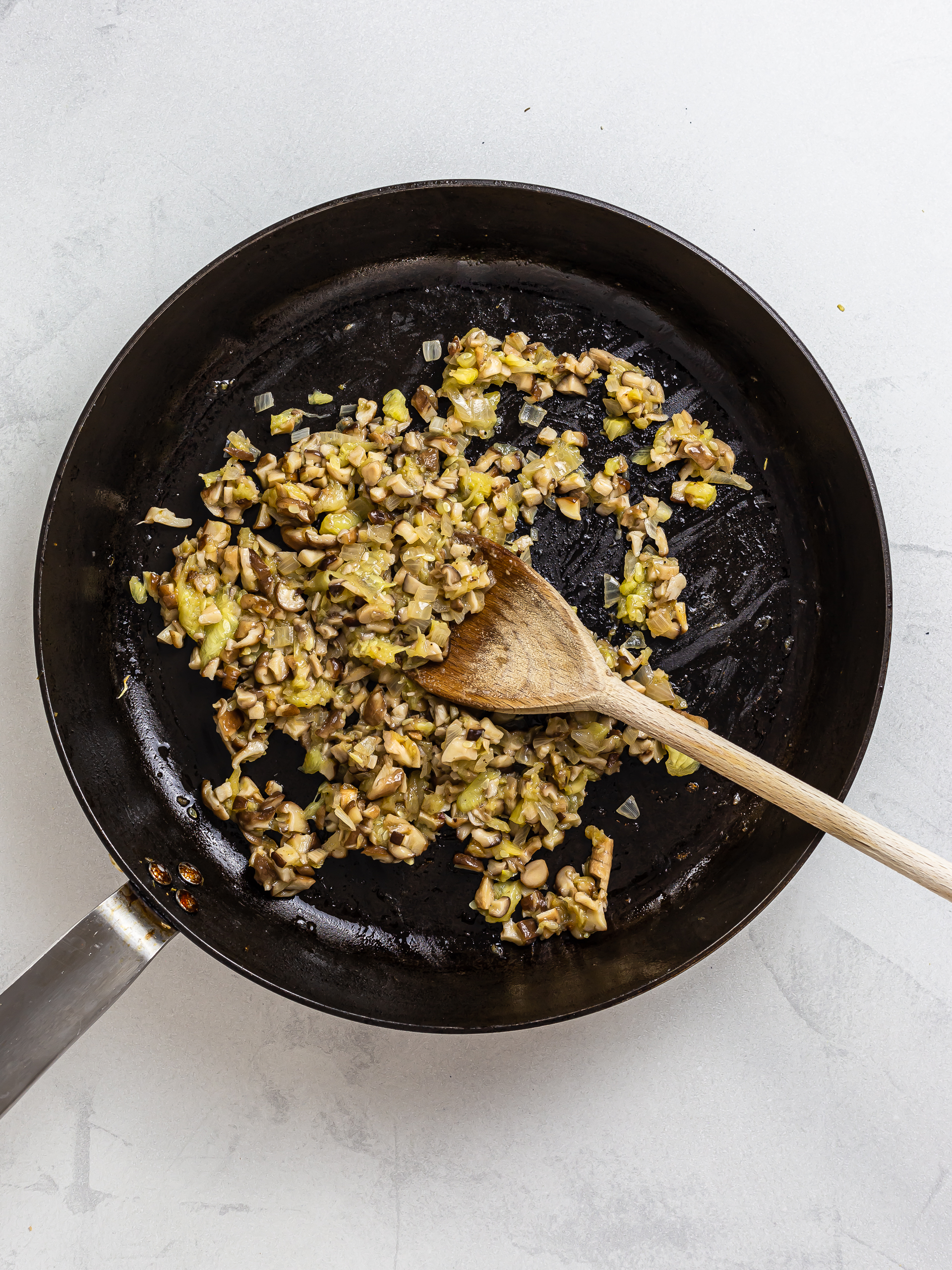 cooked mushrooms and zucchini pulp in a skillet