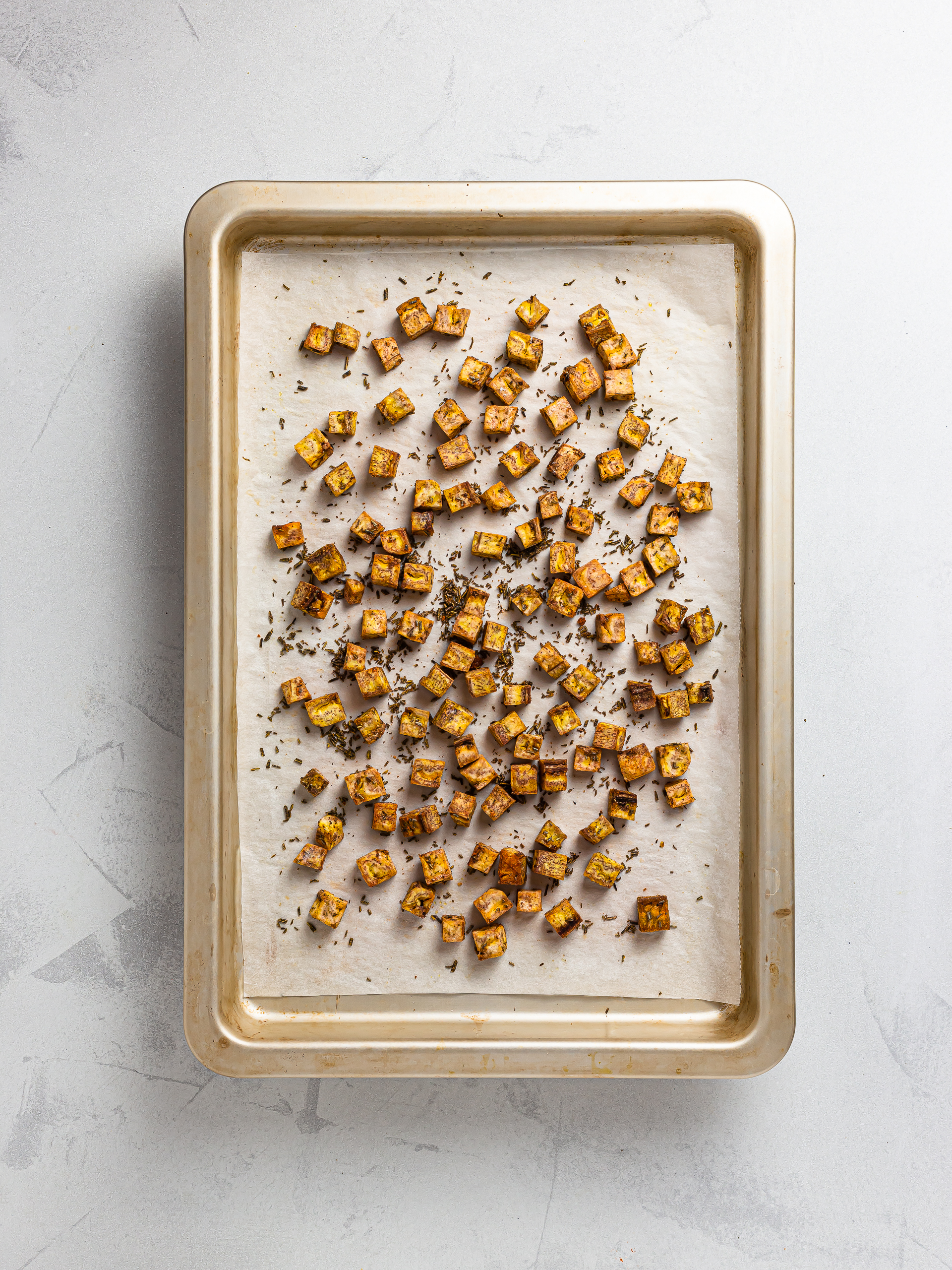 baked plantain croutons on a tray